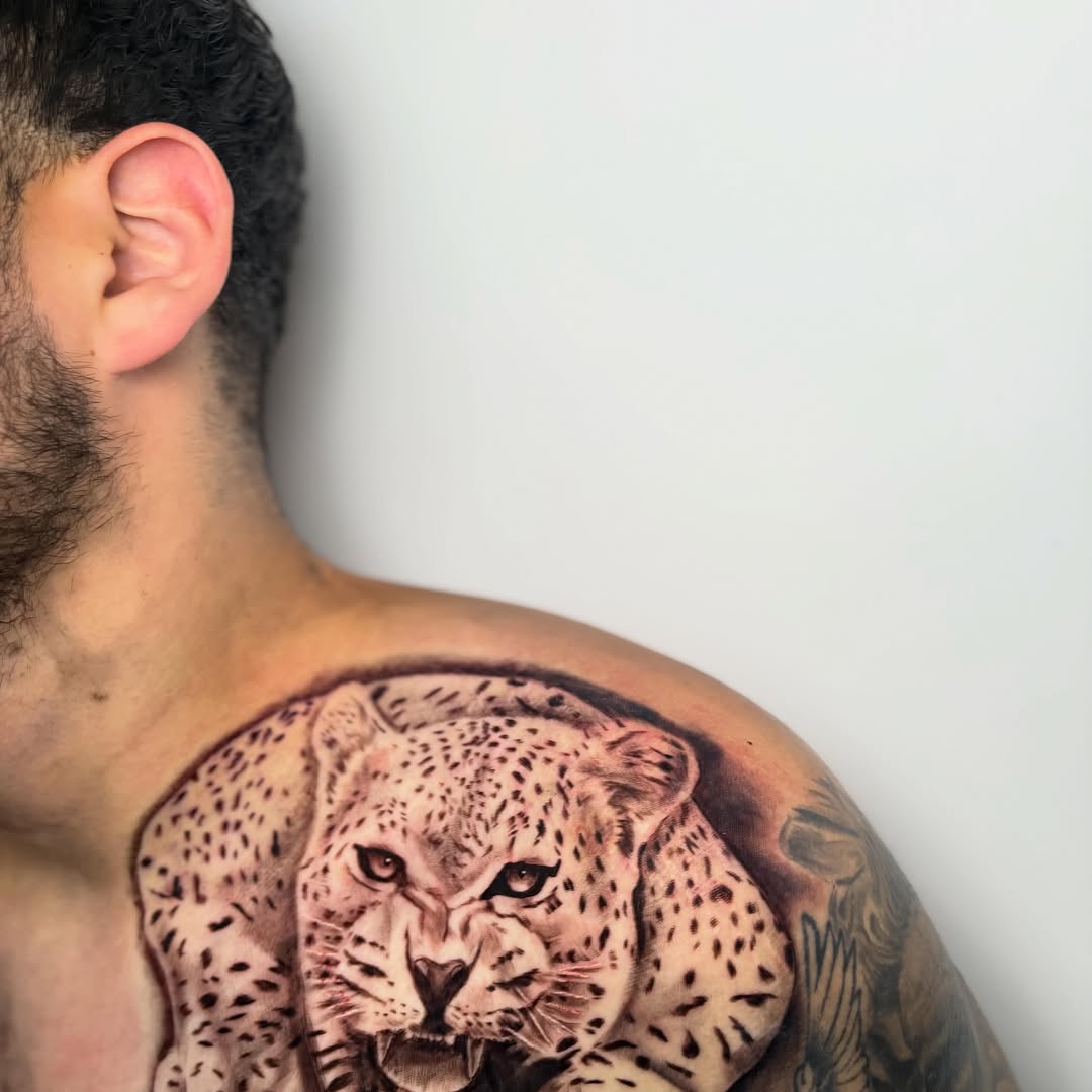 Leopard portrait realism tattoo on the chest by Koolz
