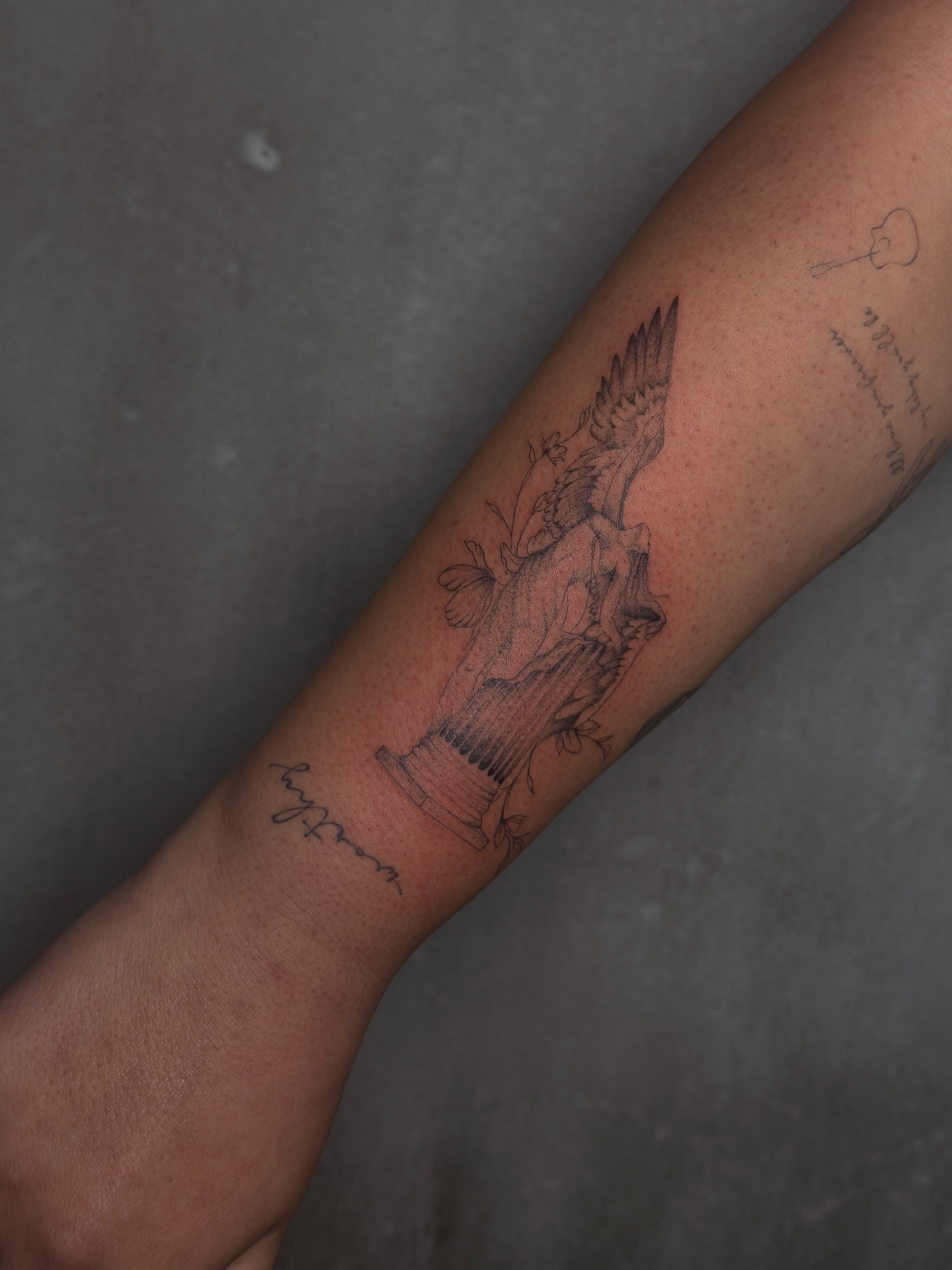 Statue with eagle black and grey tattoo on the forearm by 𝙸𝚗𝚔𝚊𝚗𝚍𝚕𝚒𝚕𝚢𝚜 🤎💉🐻🌸