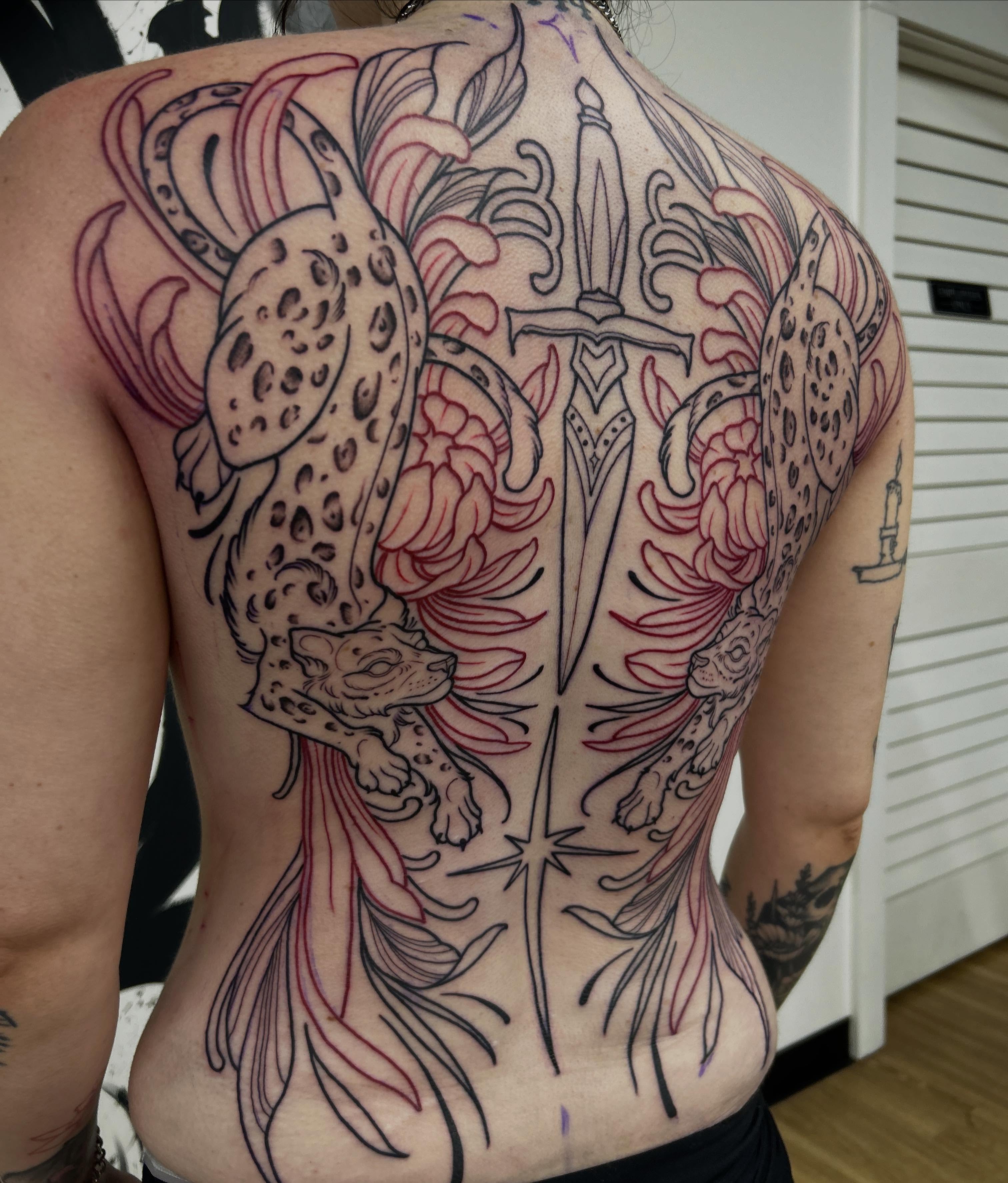 Leopard and sword neo-traditional tattoo on the back by Kayla Fay, Baton Rouge, Louisiana