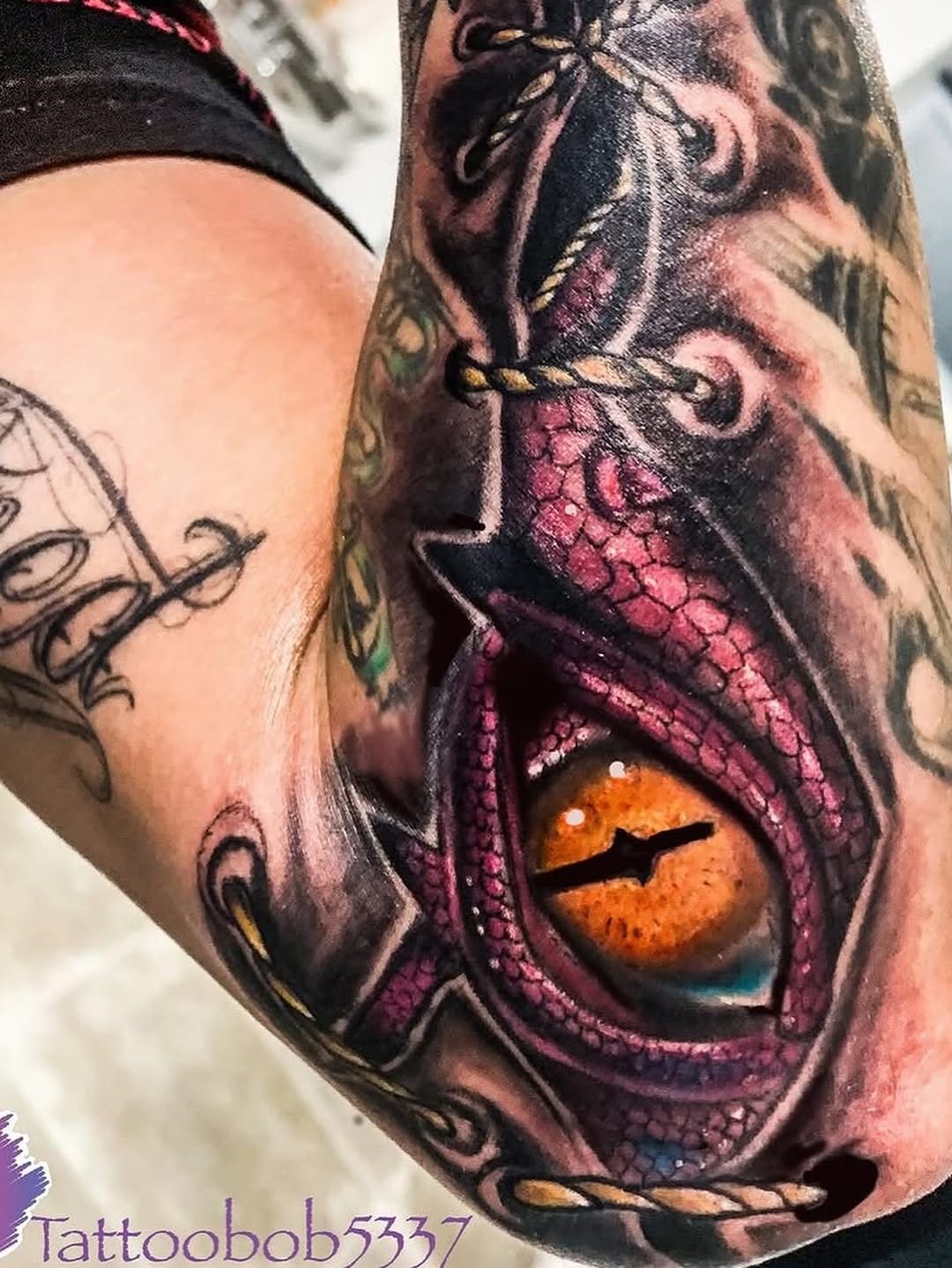 Dragon eye watercolor tattoo on the forearm by Bobby Glennon