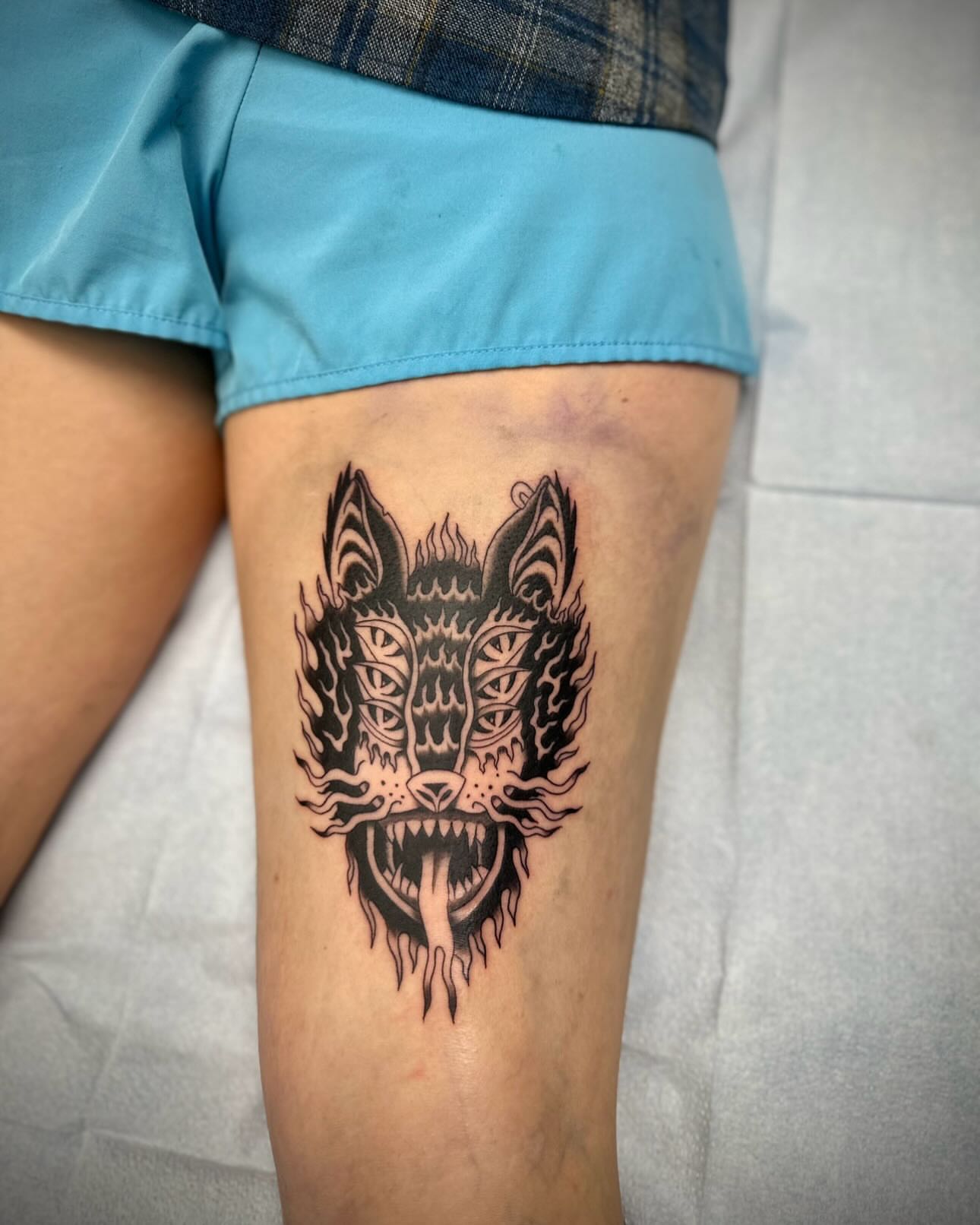 Wolf head black and grey tattoo on the thigh by rory