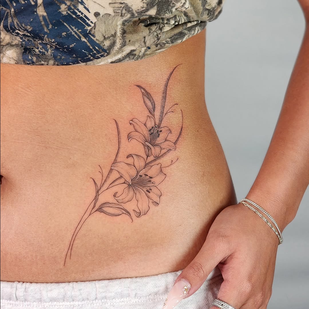 Lily black and grey tattoo on the torso by Tattoo artist - Luciana Dsilva, San Francisco, California