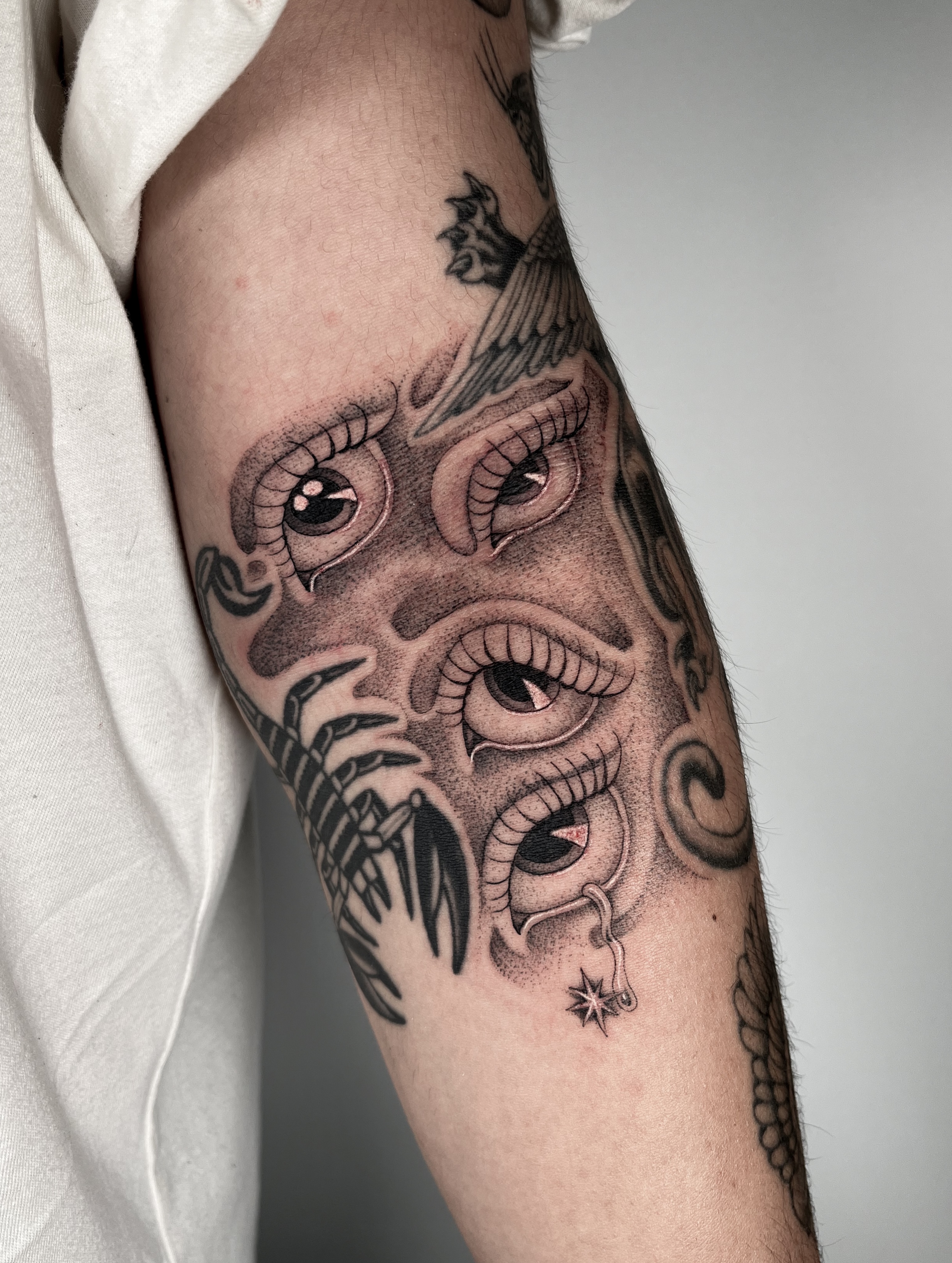 Mask with eyes realism tattoo on the forearm by The One Who’s Always Drawing