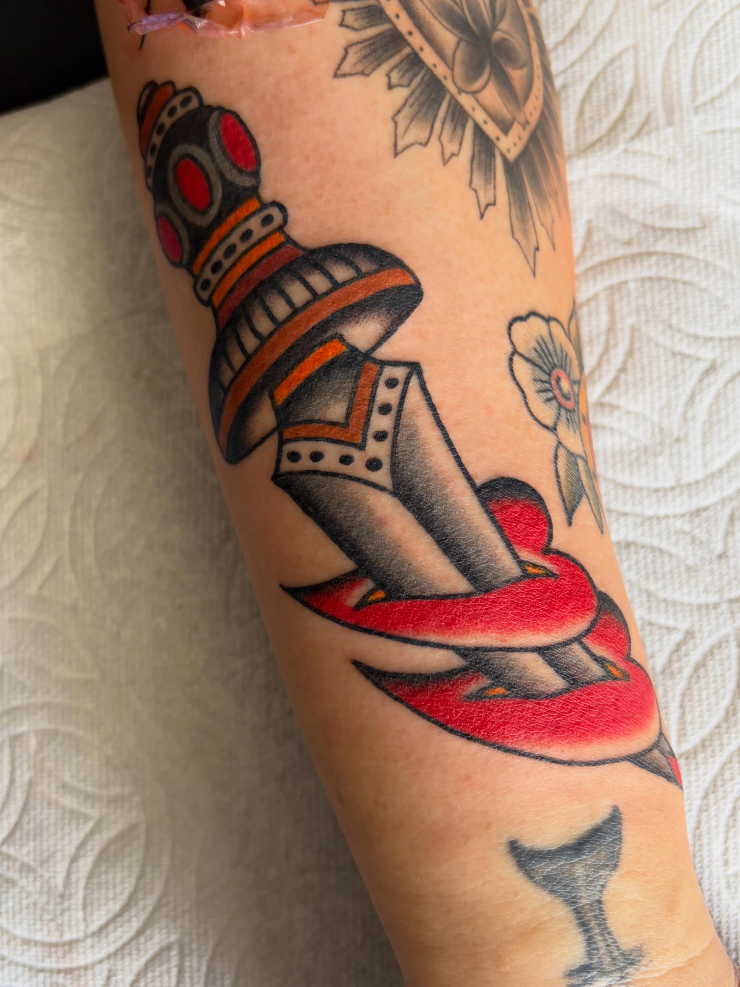 Boot and snake American traditional tattoo on the forearm by Kelsey Lane