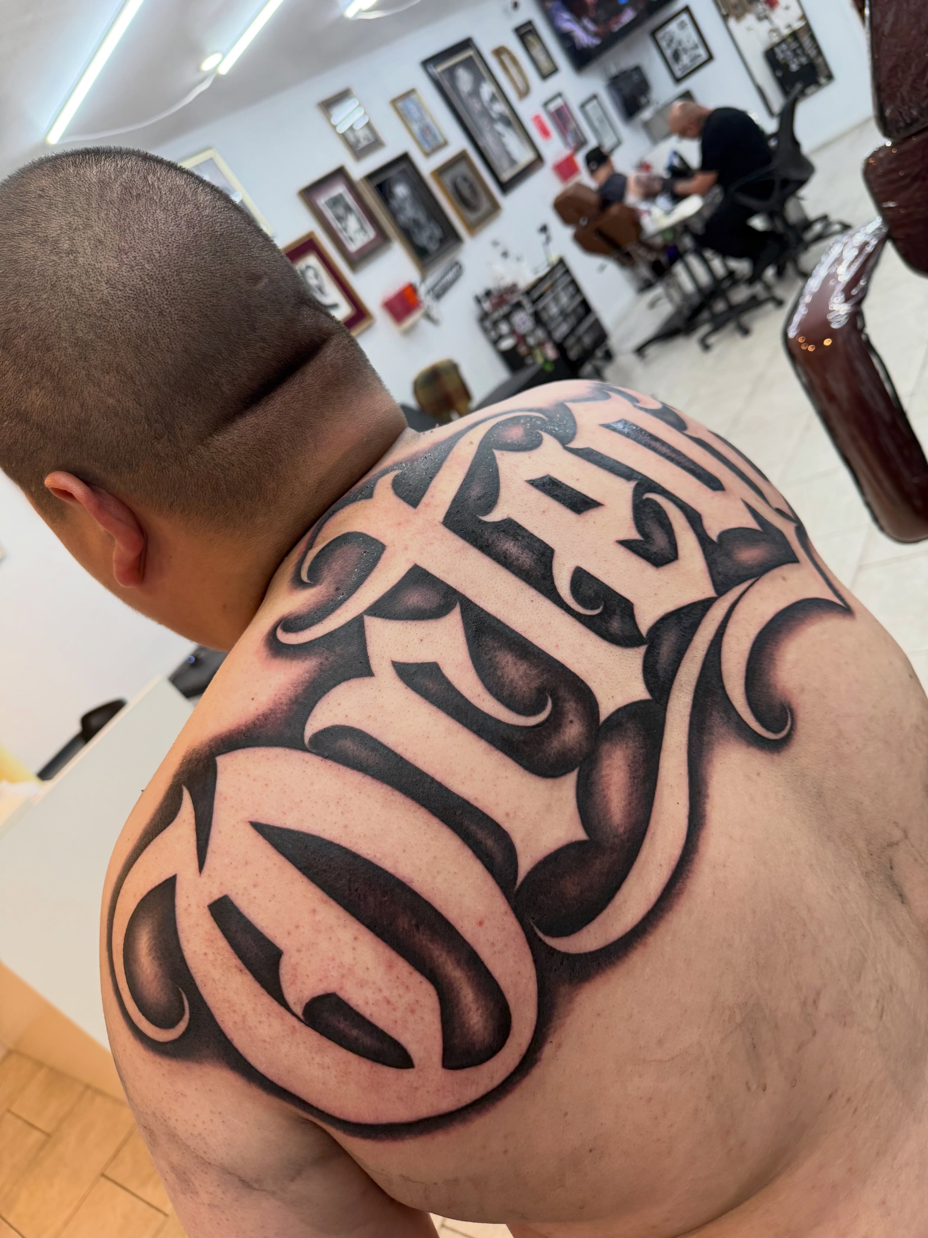 Script lettering lettering script tattoo on the shoulder by Daniel Lopez Tattoos