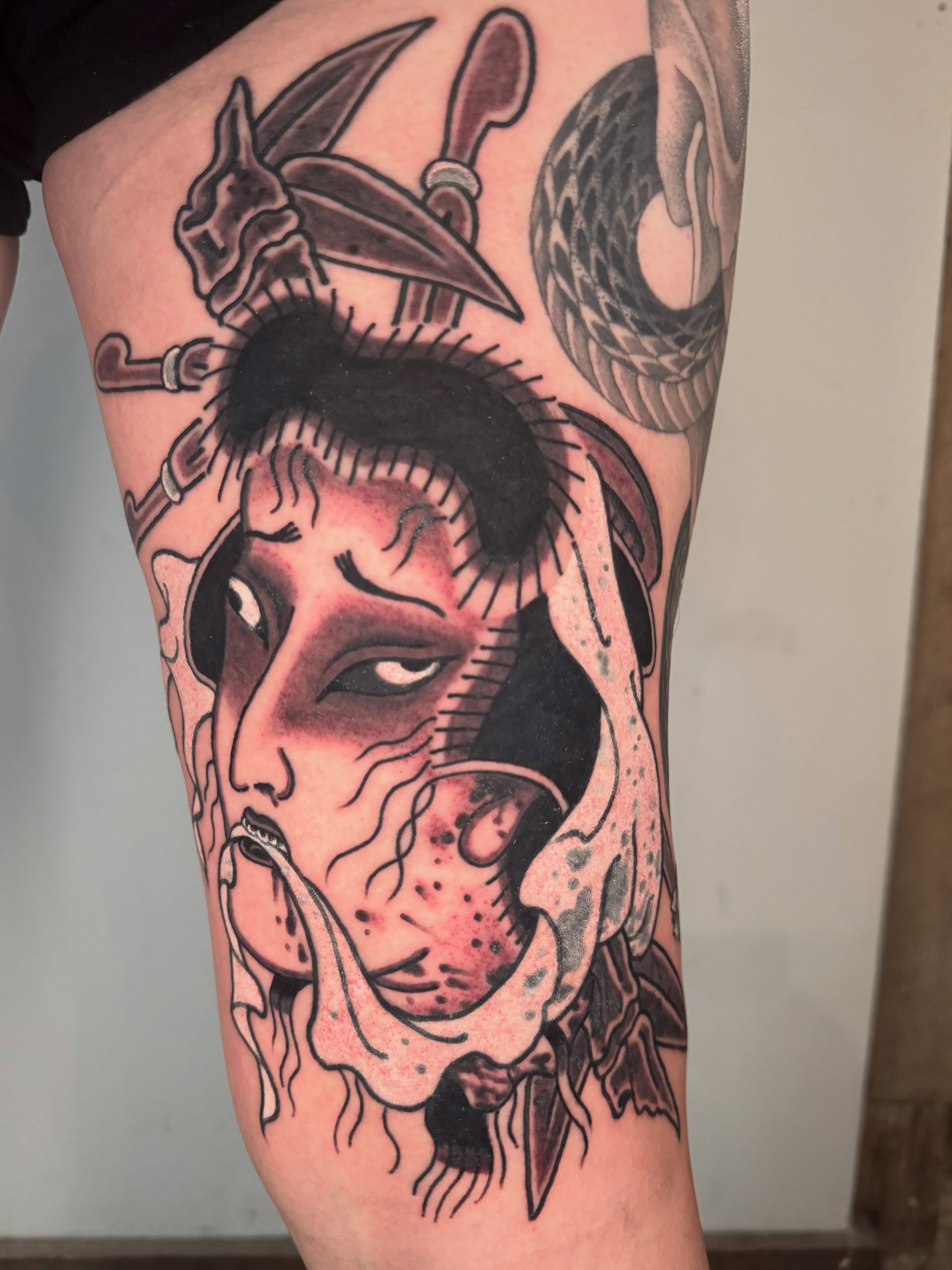 Woman's face American traditional tattoo on the thigh by Mr Nikita, New York, New York