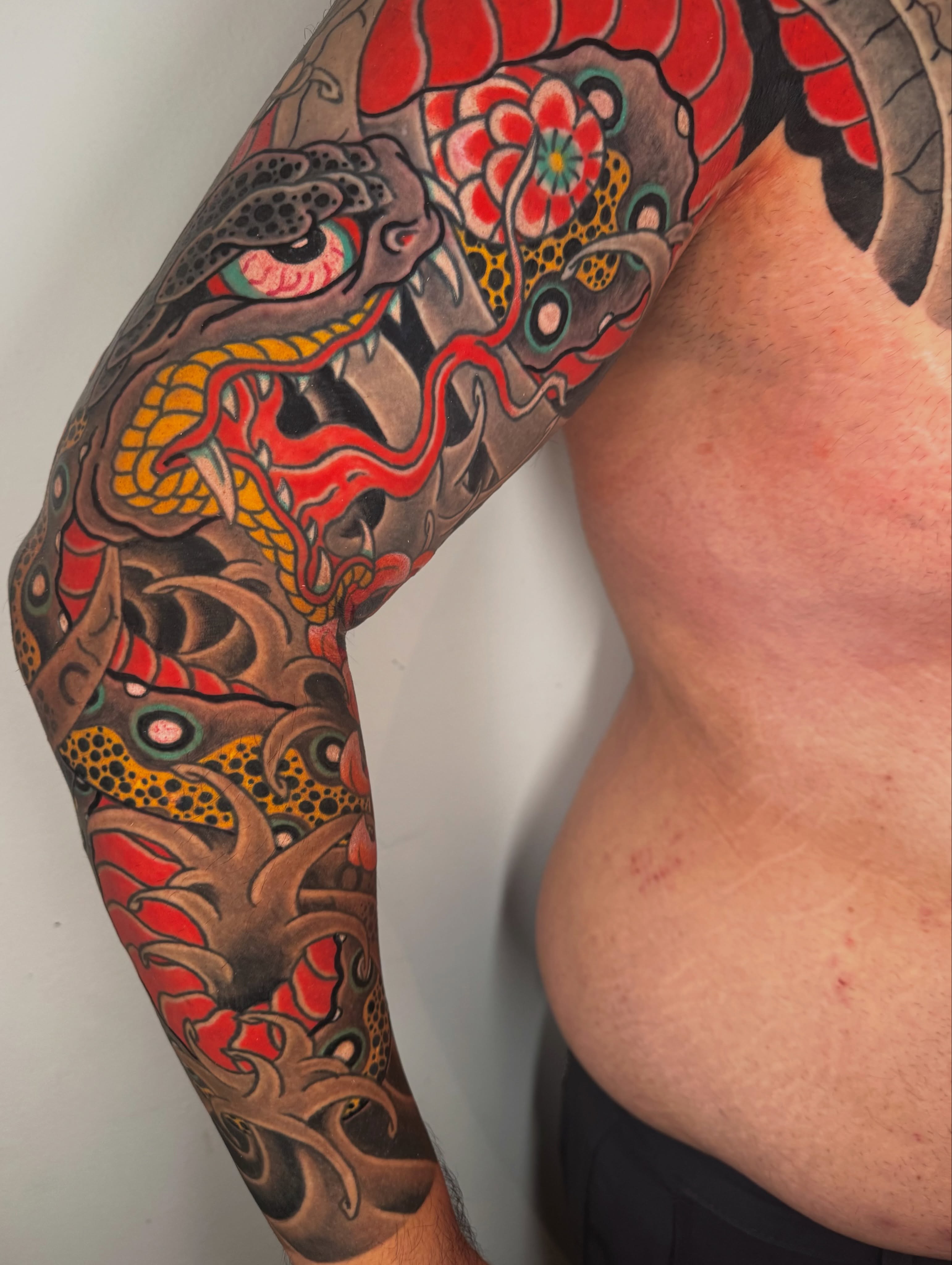 Snake and peony japanese irezumi tattoo on the upper arm by Mr Nikita, New York, New York