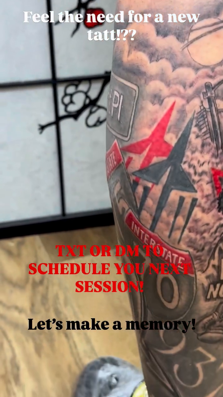 Cityscape with red accents tattoo on the upper arm by Sk Pierce