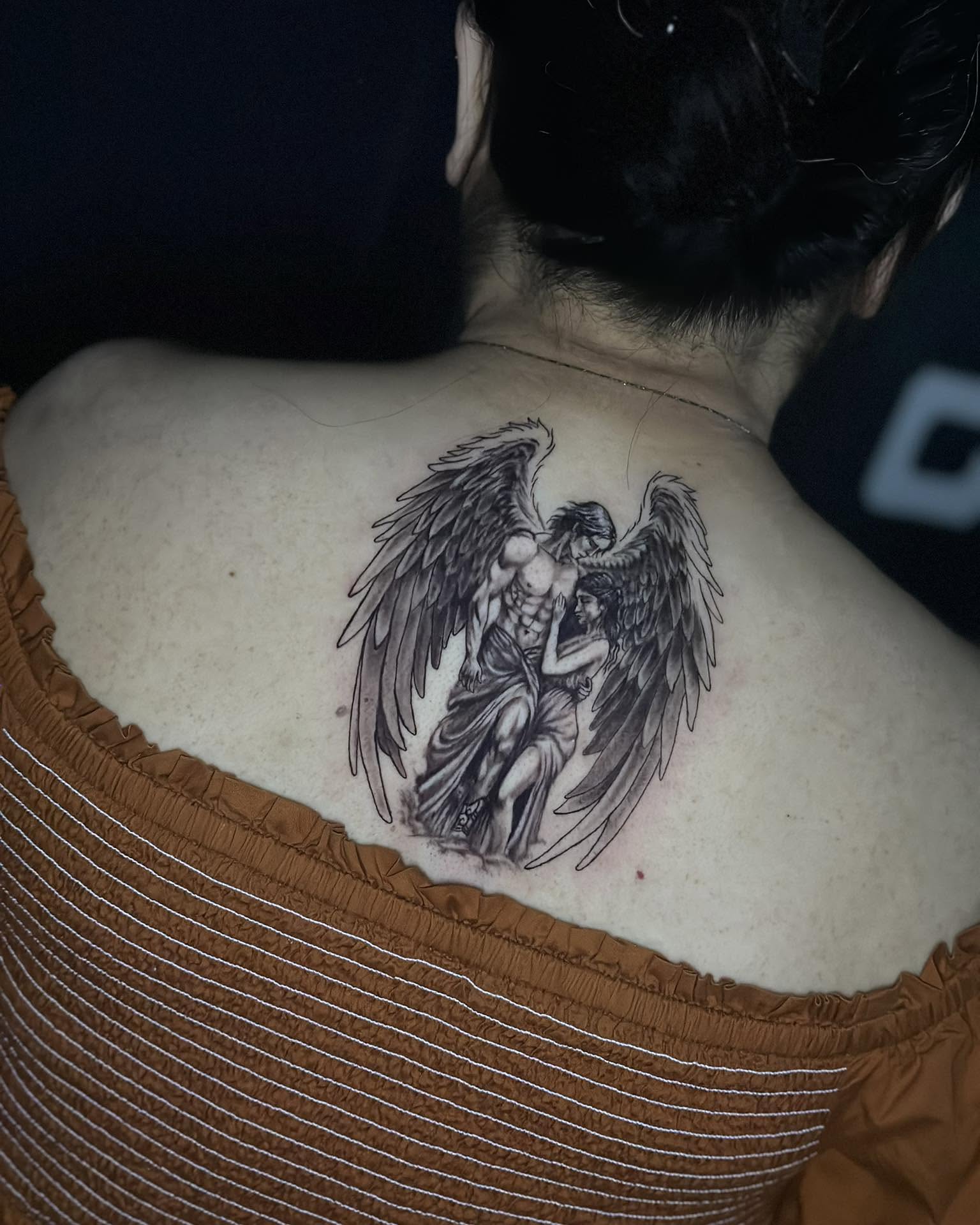 Angel and cherub black and grey tattoo on the back by Stephen Degracia