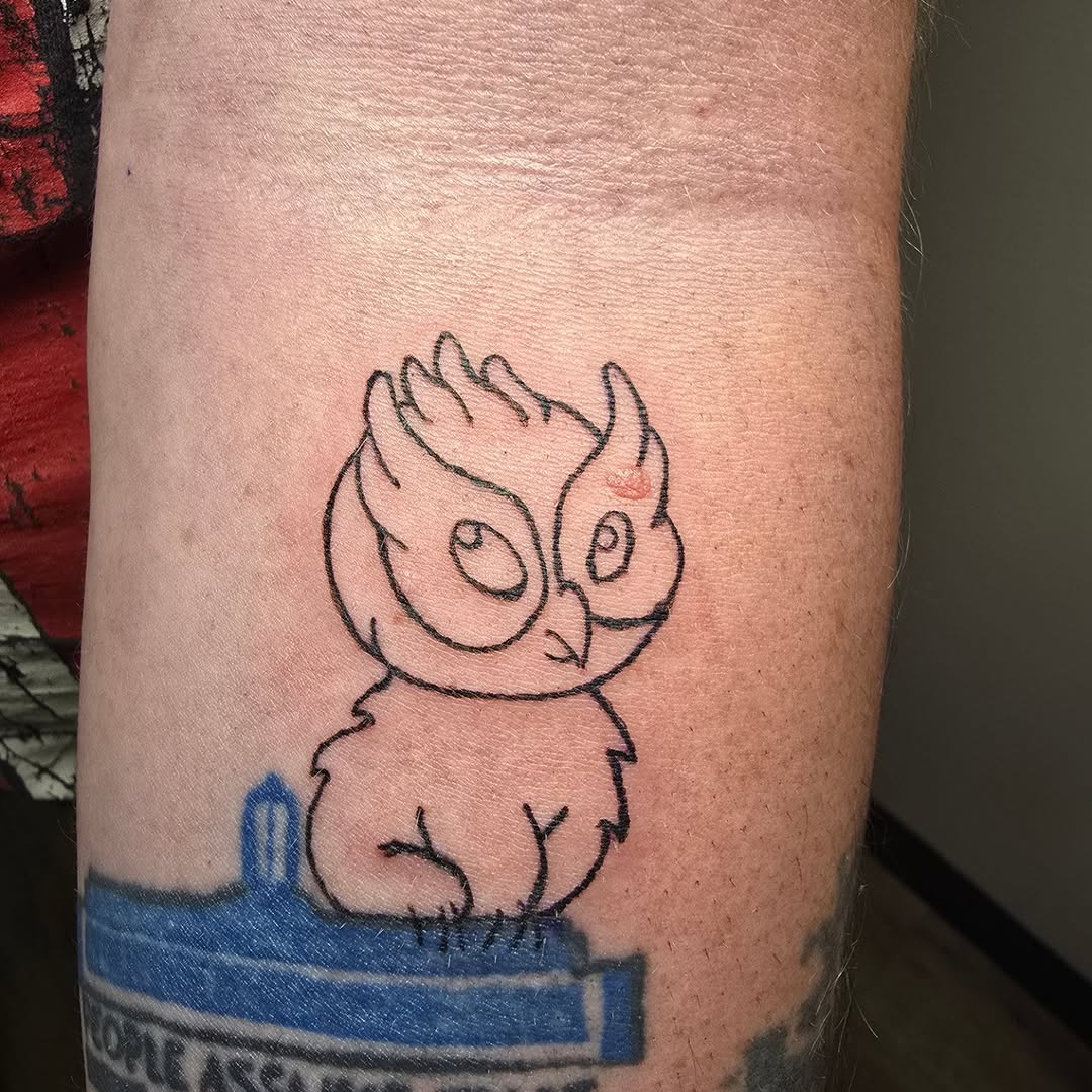 Cartoon owl tattoo on the forearm by Catherine B