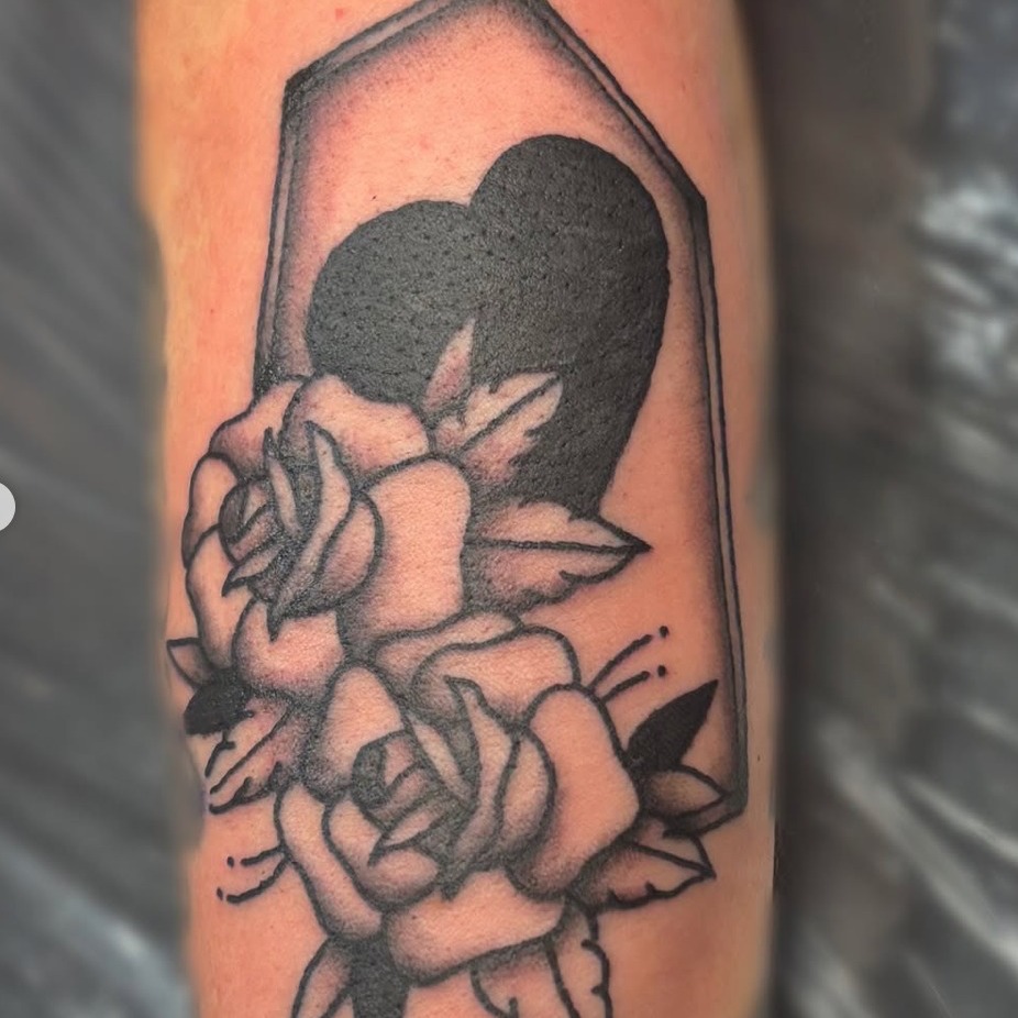 Casket with roses black and grey tattoo on the forearm by Bree Burgess