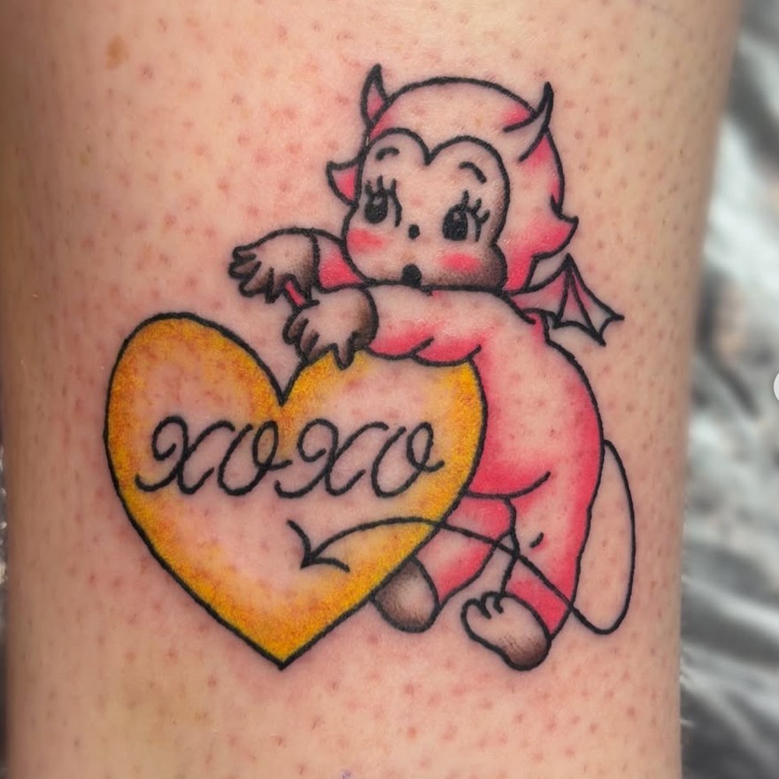 Baby devil with heart American traditional tattoo on the forearm by Bree Burgess