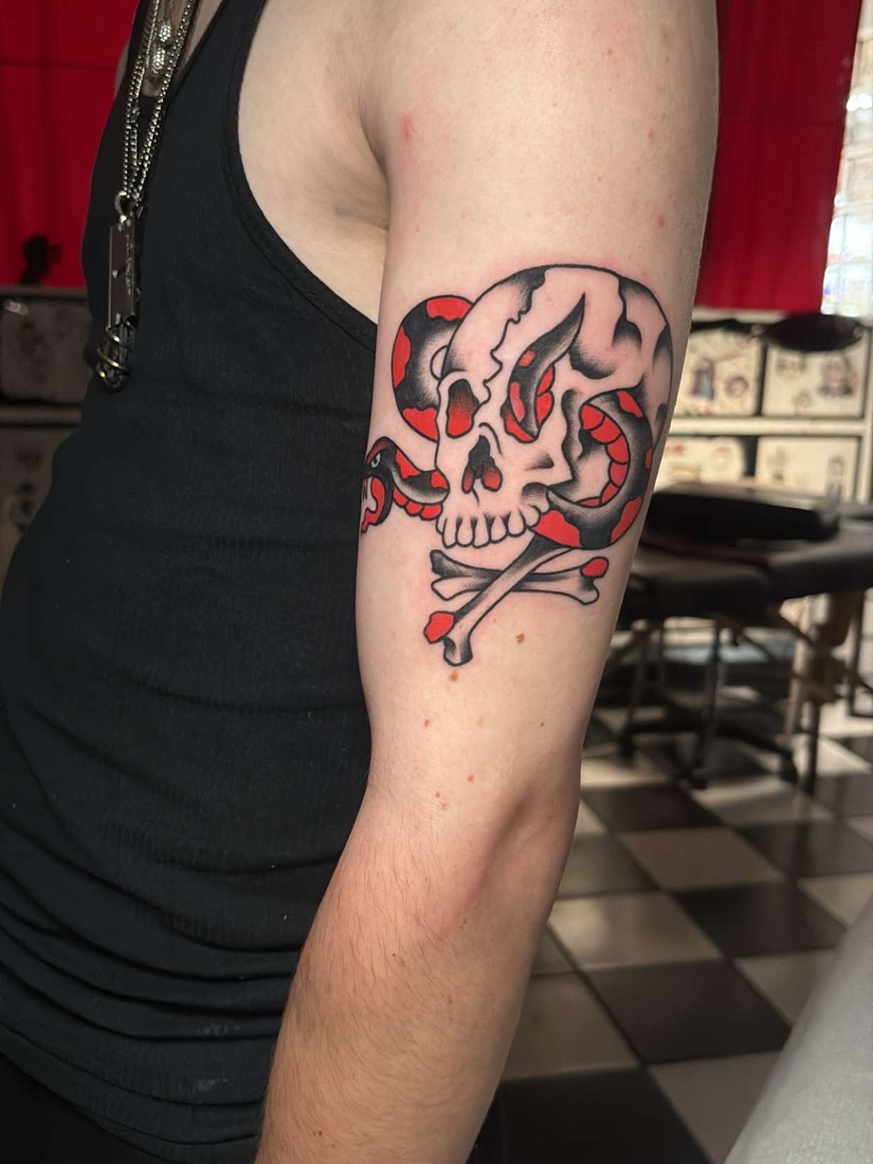 Skull and crossbones American traditional tattoo on the forearm by Chris Prince Jr., Miamisburg, Ohio