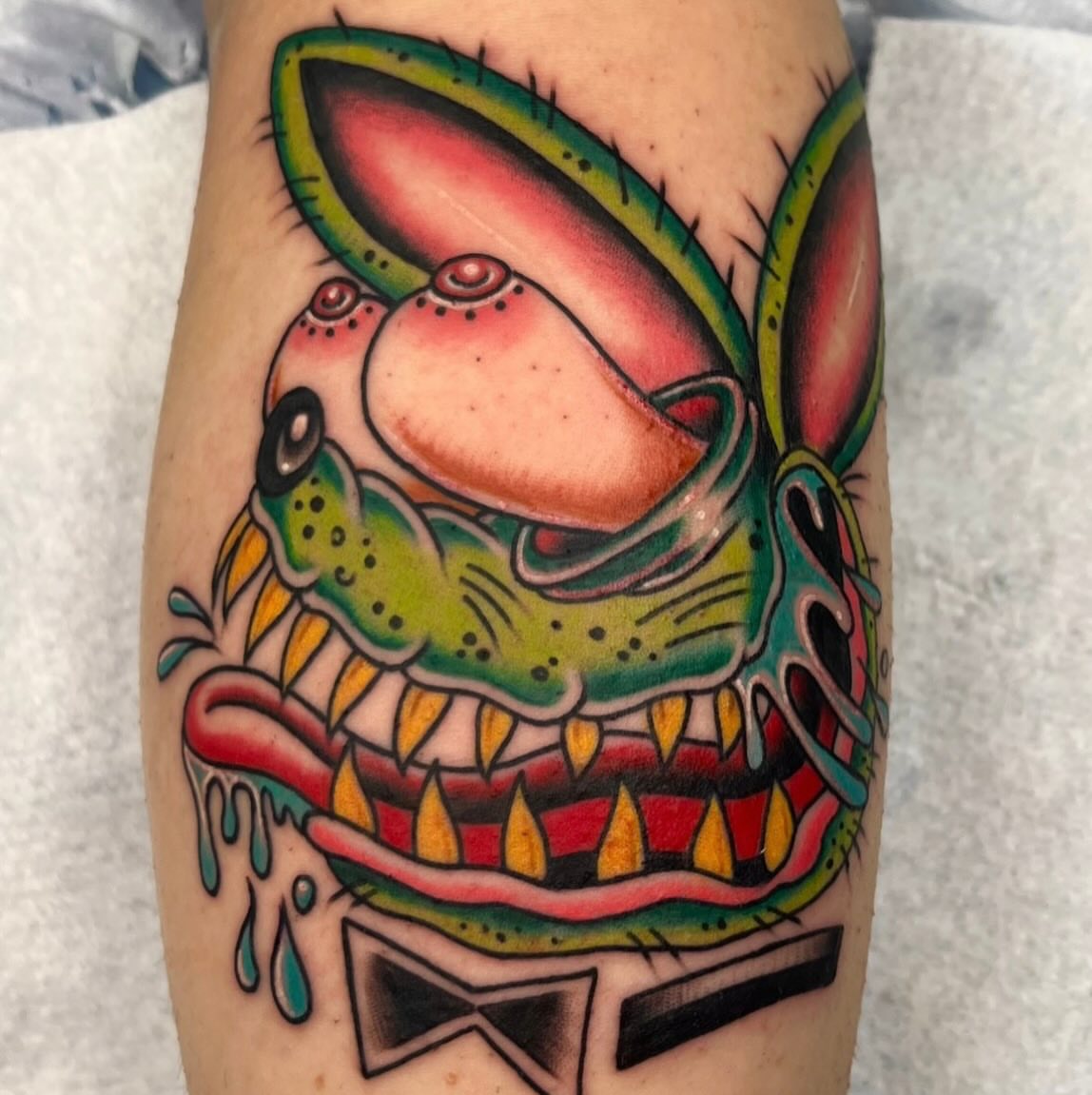 Alien head American traditional tattoo on the forearm by Macy Bird