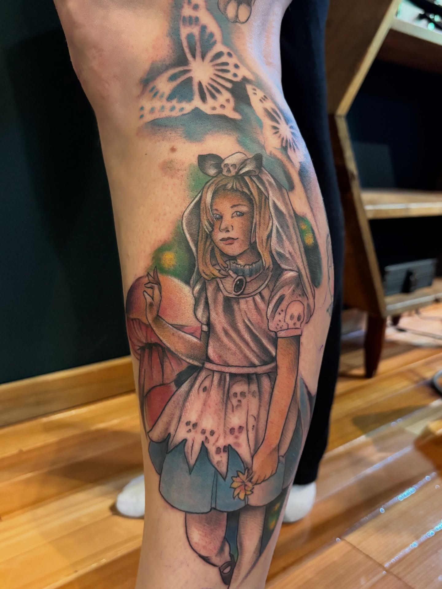 Alice in wonderland realism tattoo on the forearm by Komfort Kristy