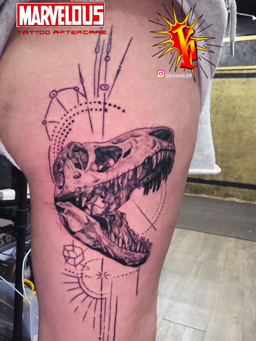 Dinosaur skull with geometric elements realism tattoo on the thigh by komik tattoos