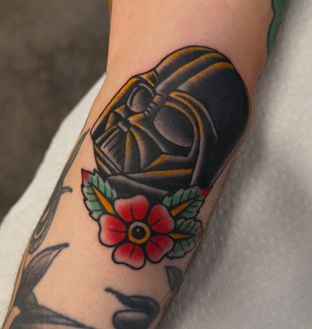 Darth vader helmet with flower American traditional tattoo on the forearm by Christopher Mikesell