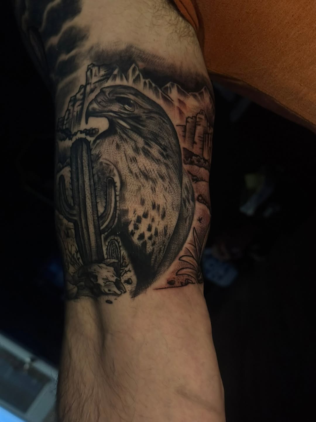 Hawk in desert landscape fine line tattoo on the forearm by Rebecca Cansler