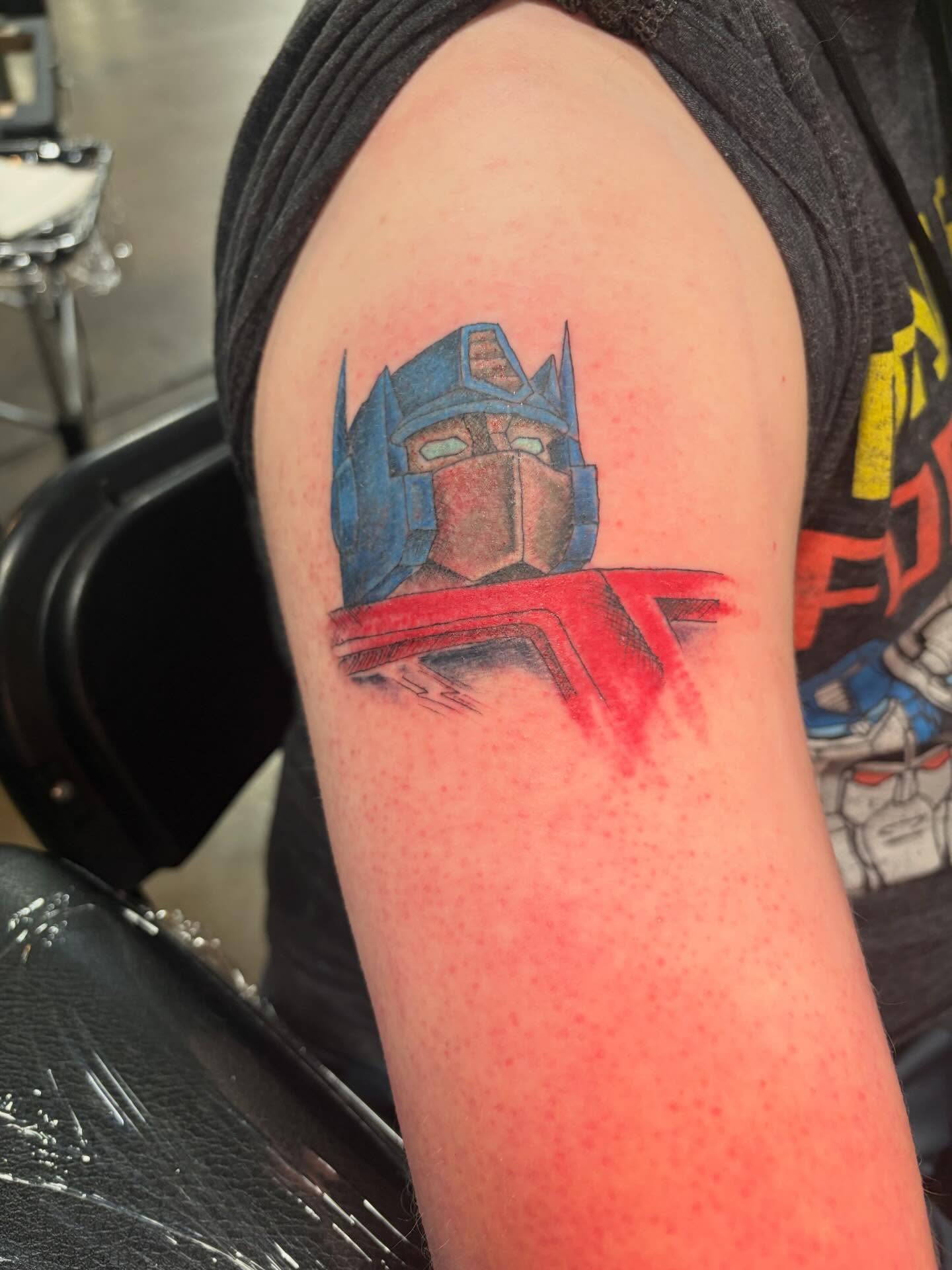 Optimus prime realism tattoo on the forearm by Fredrick Tigerman