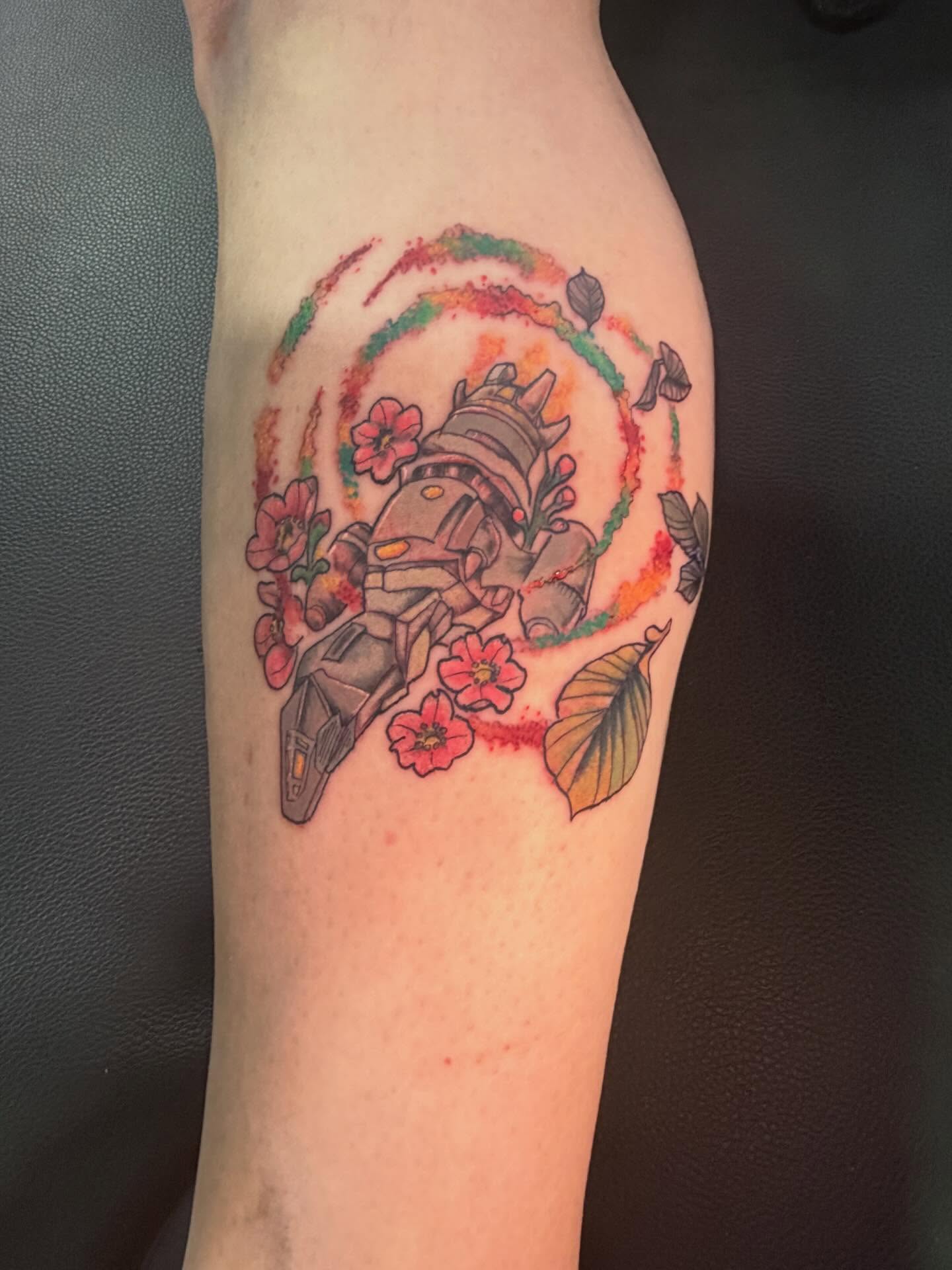 Mecha with flowers new school tattoo on the forearm by Fredrick Tigerman