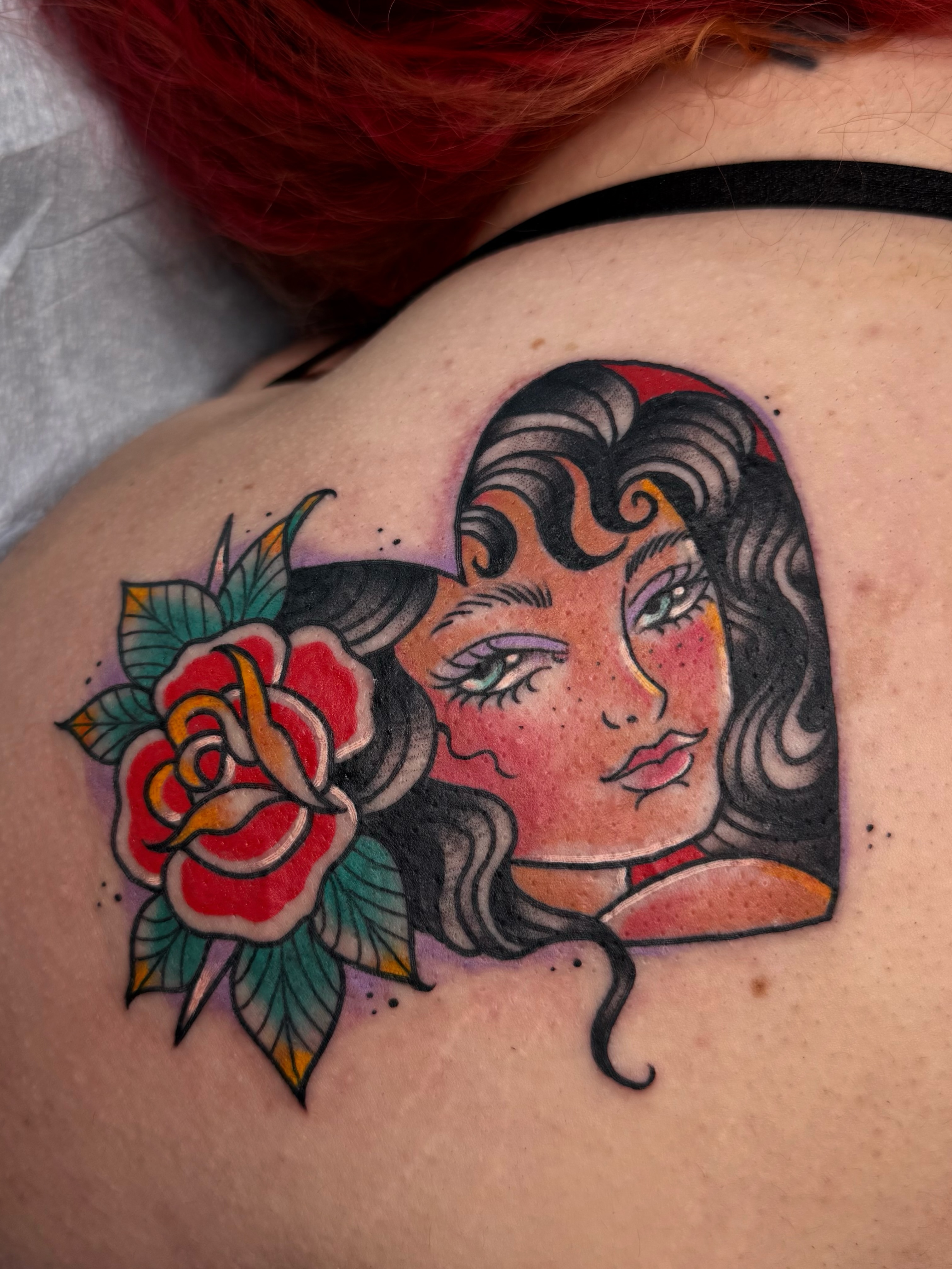 Woman with rose American traditional tattoo on the shoulder by Chelsea Graham, Seattle, Washington
