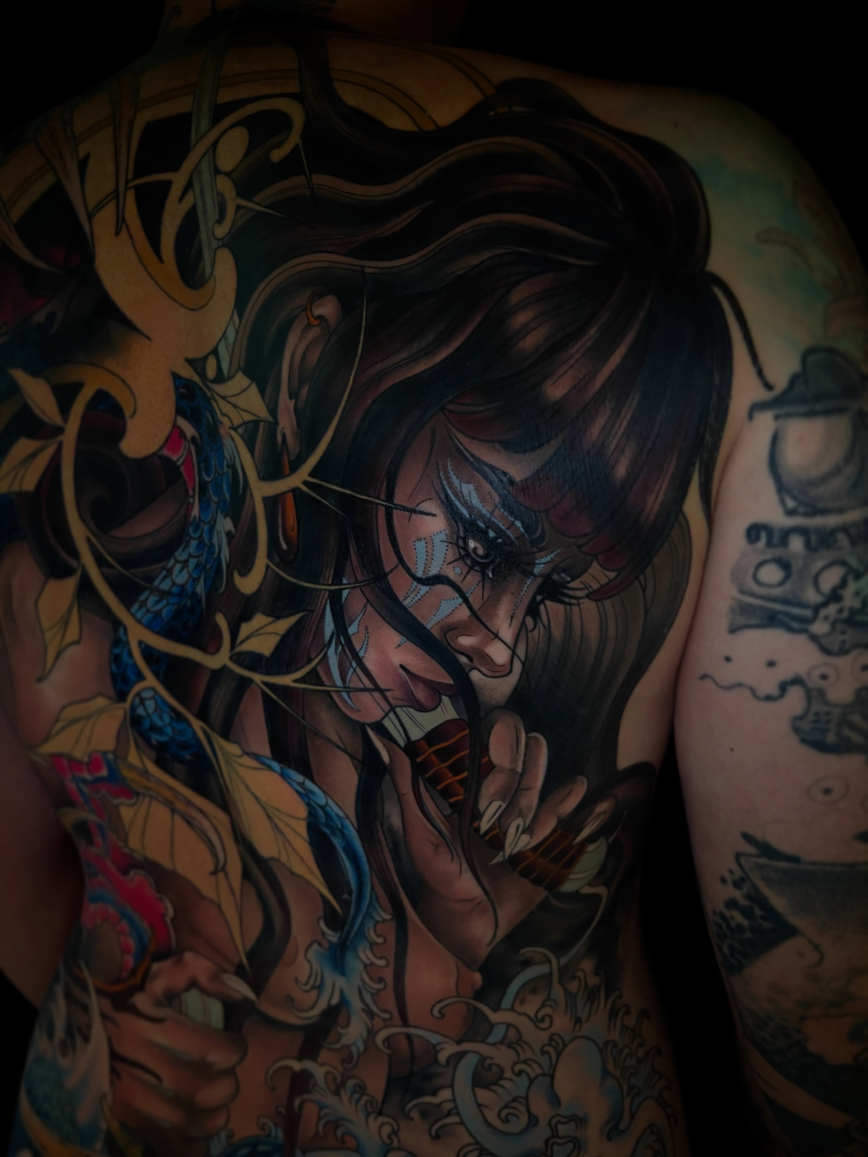 Woman with long hair realism tattoo on the back by <