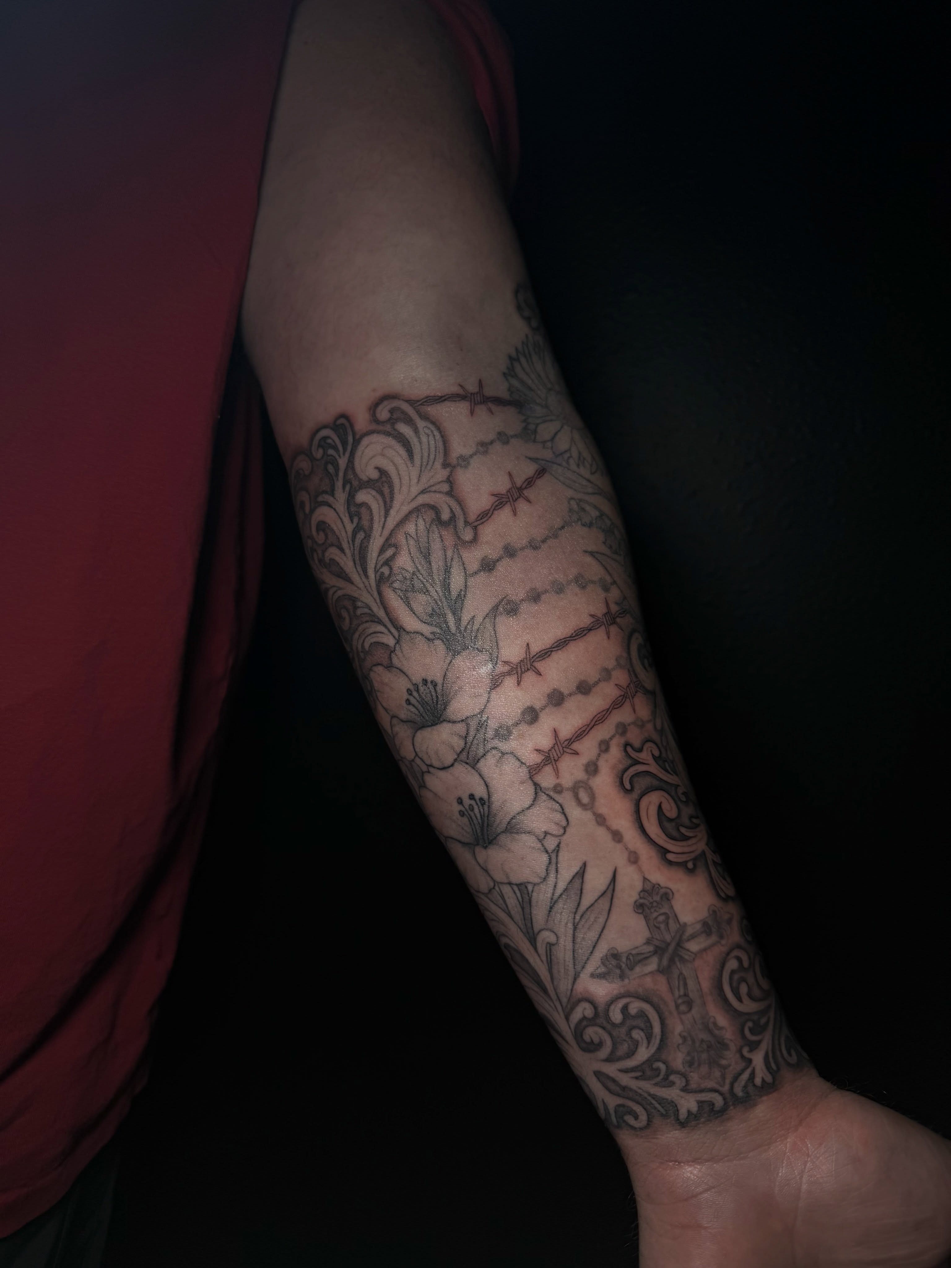 Rosary and floral black and grey tattoo on the forearm by Ink Darling, Carlisle, Iowa