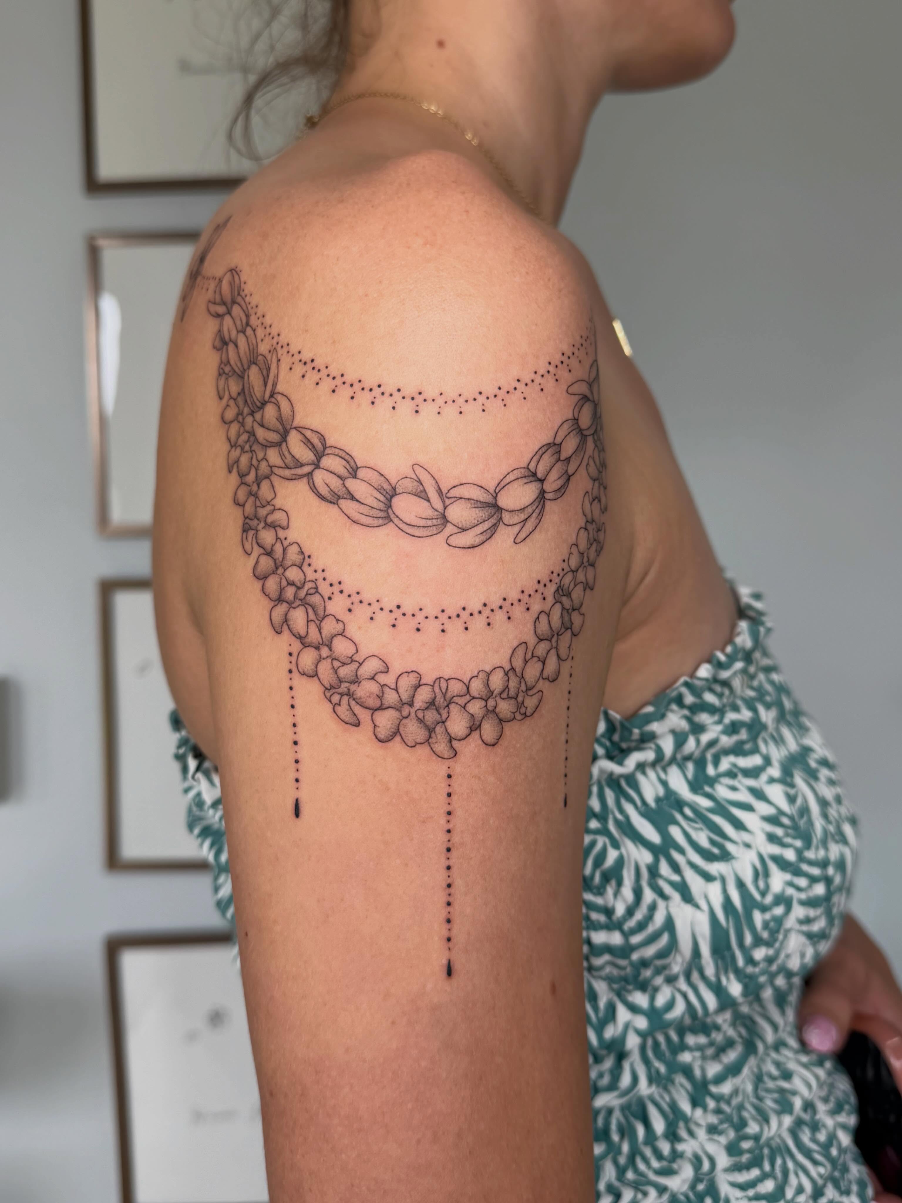 Flower chain dotwork tattoo on the shoulder by Priscila - HAWAII TATTOO
