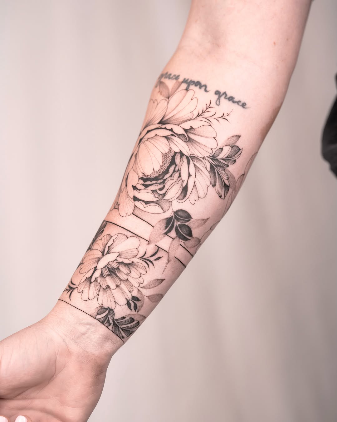 Floral bouquet black and grey tattoo on the forearm by Leo Gao