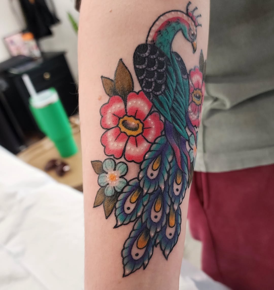 Peacock and flowers new school tattoo on the forearm by mikayla