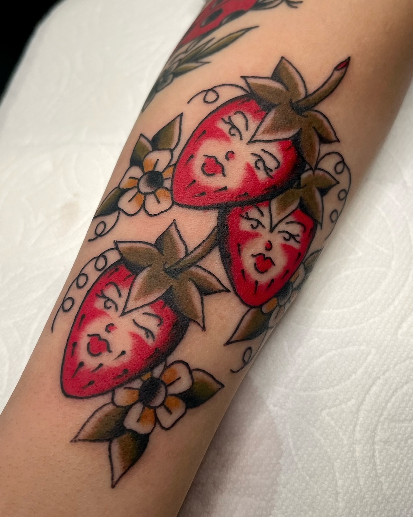 Strawberries American traditional tattoo on the forearm by Tiffani Thompson, San Diego, California