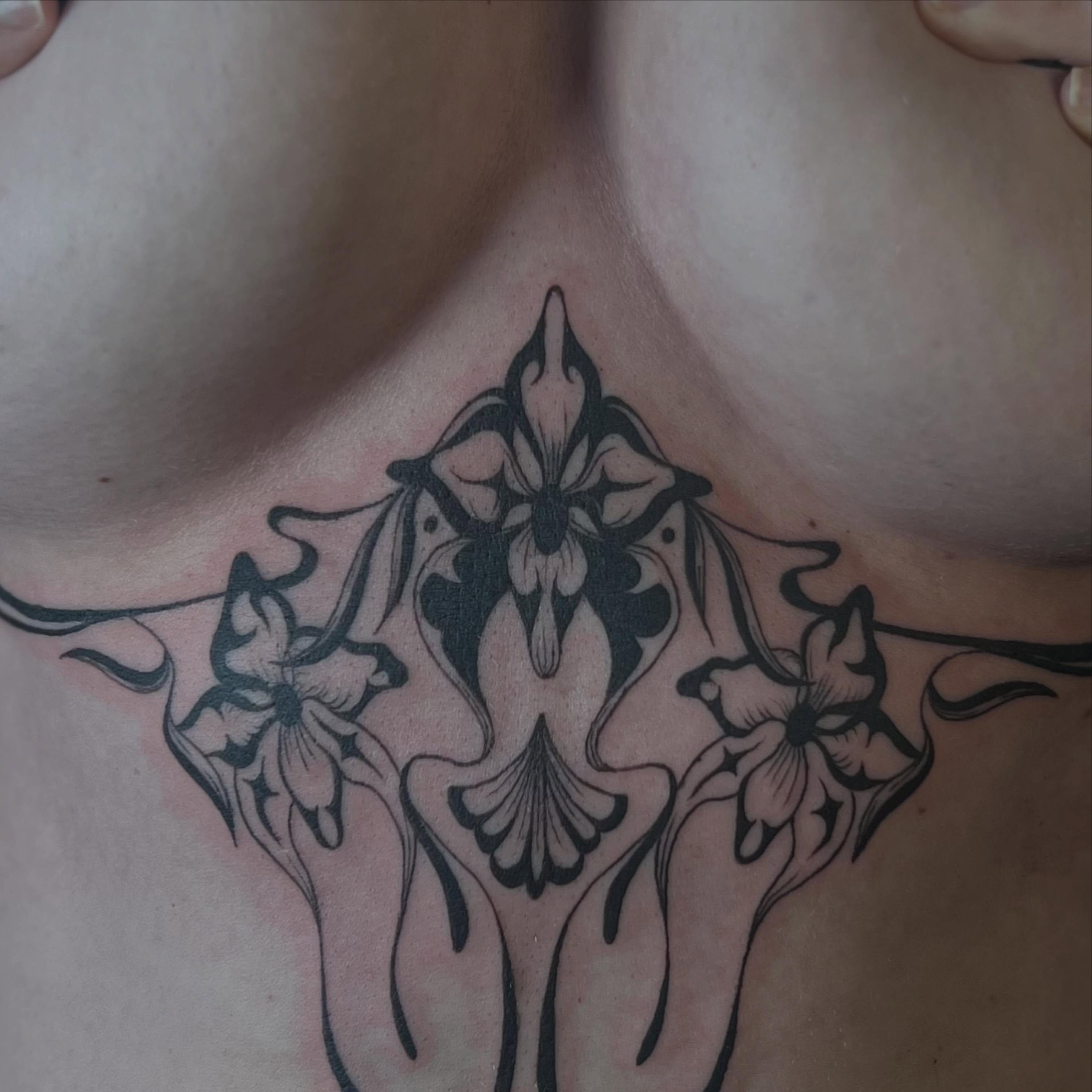 Floral design black and grey tattoo on the chest by Alex