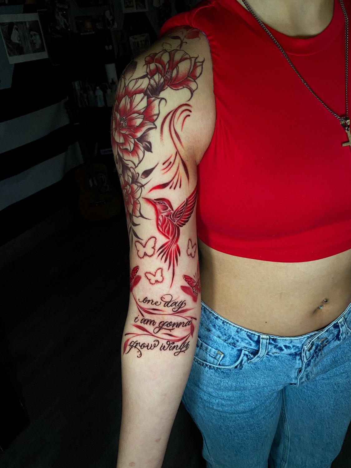 Bird and flowers American traditional tattoo on the upper arm by Kelan Mckenna