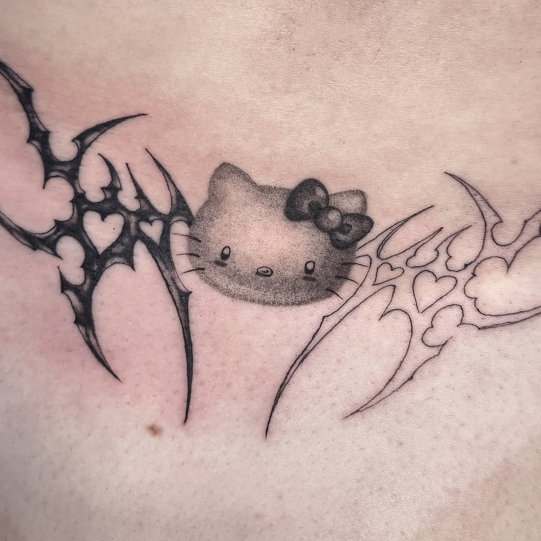 Hello Kitty black and grey tattoo on the chest by 𝕮𝖞𝖇𝖊𝖗𝕾𝖎𝖌𝖎𝖑𝖎𝖘𝖒
