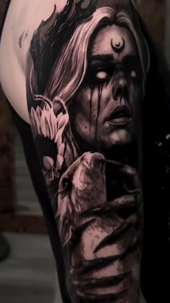 Woman with crown and torn skin dark realism tattoo by Chuck James, Roseville, California