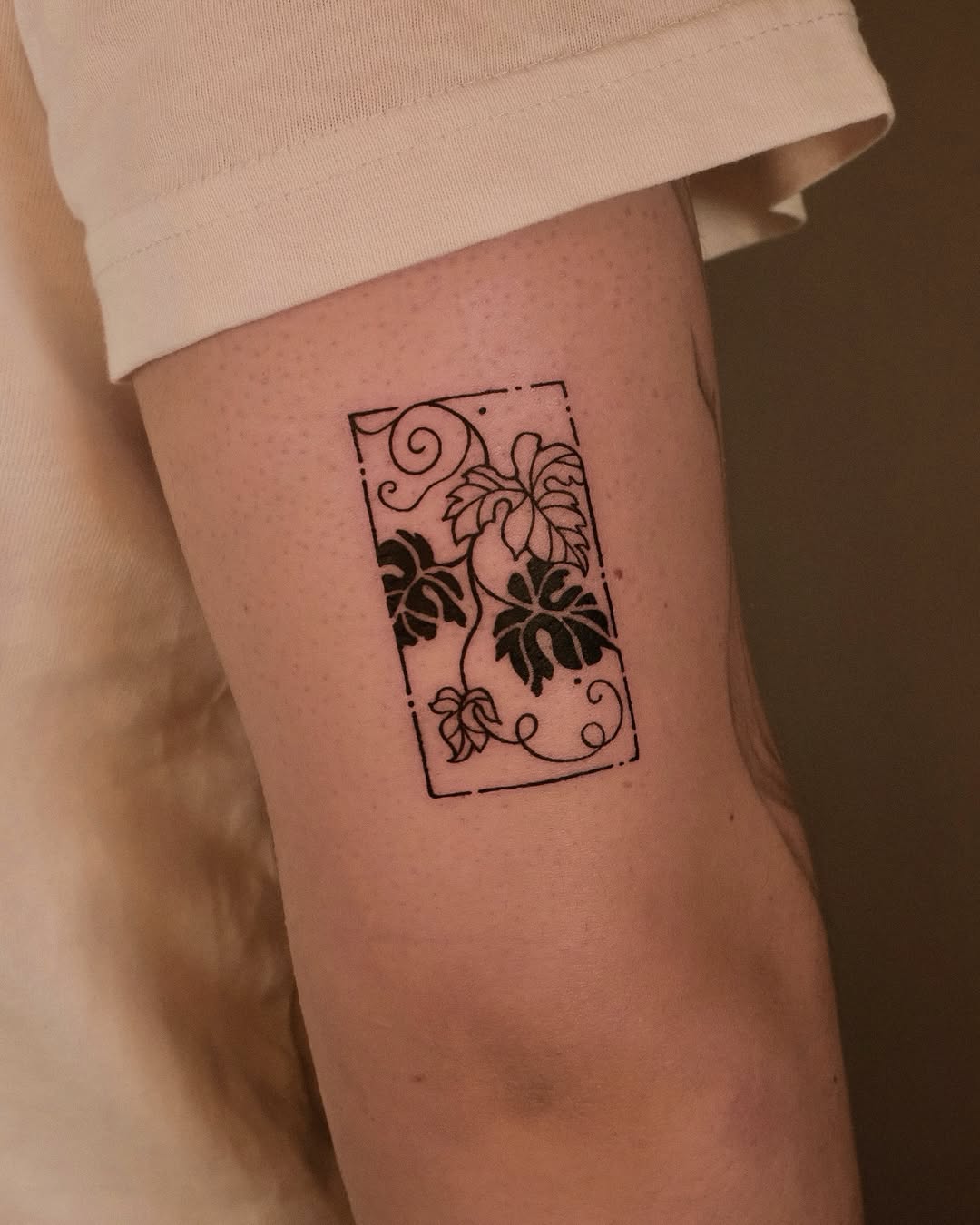 Leaves and vines in a frame minimalist tattoo on the forearm by ❖ Tomi ❖