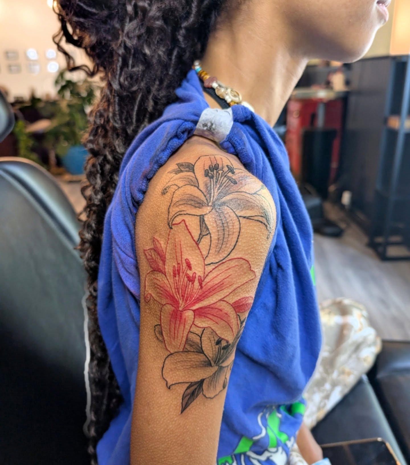 Lilies realism tattoo on the upper arm by Ashton Allen-Ruiz, Portland, Oregon