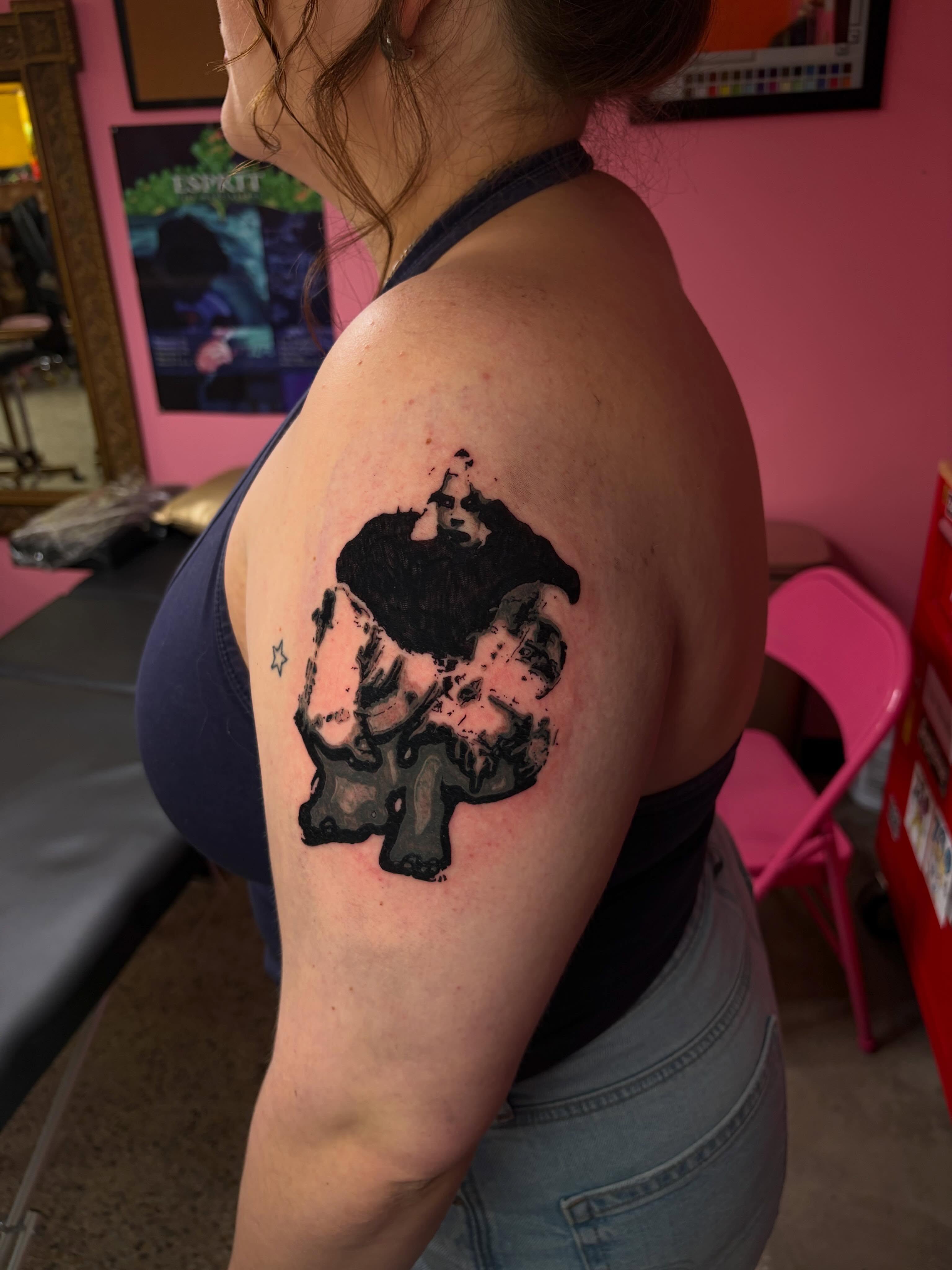 Woman with hat black and grey tattoo on the shoulder by neal