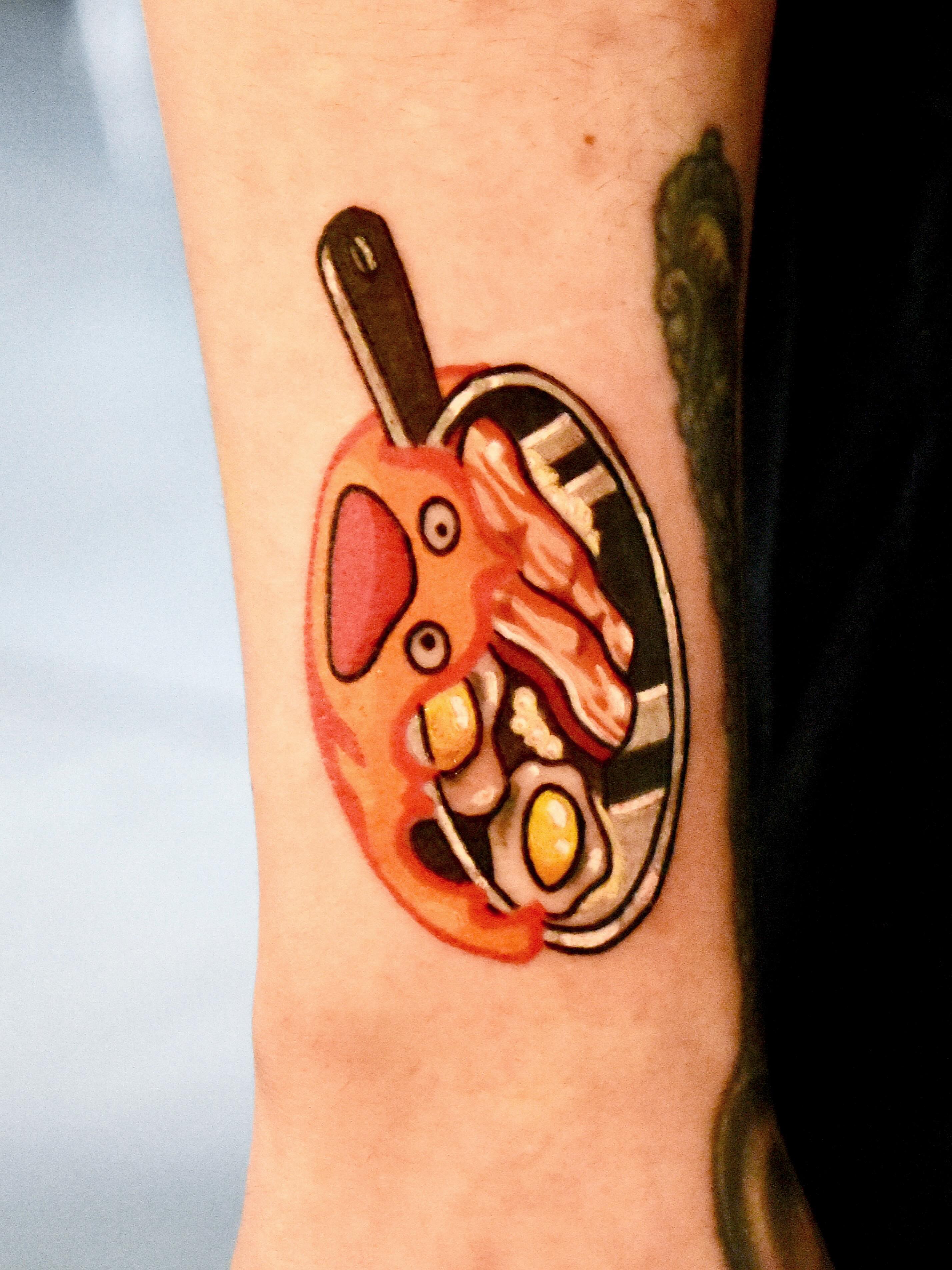 Pan of eggs and bacon dotwork tattoo on the forearm by Mackz