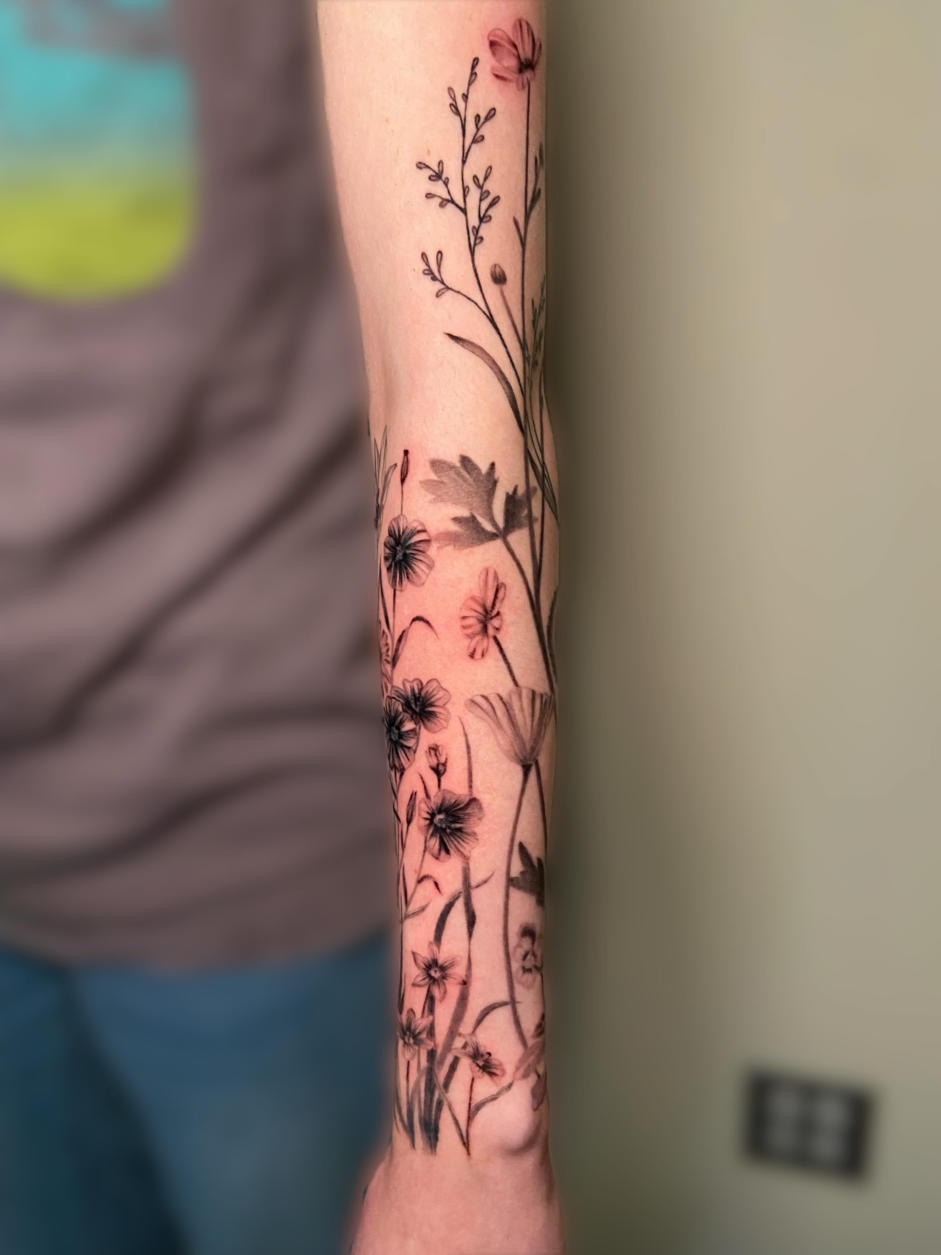 Floral arrangement realism tattoo on the forearm by Ezra Gonda