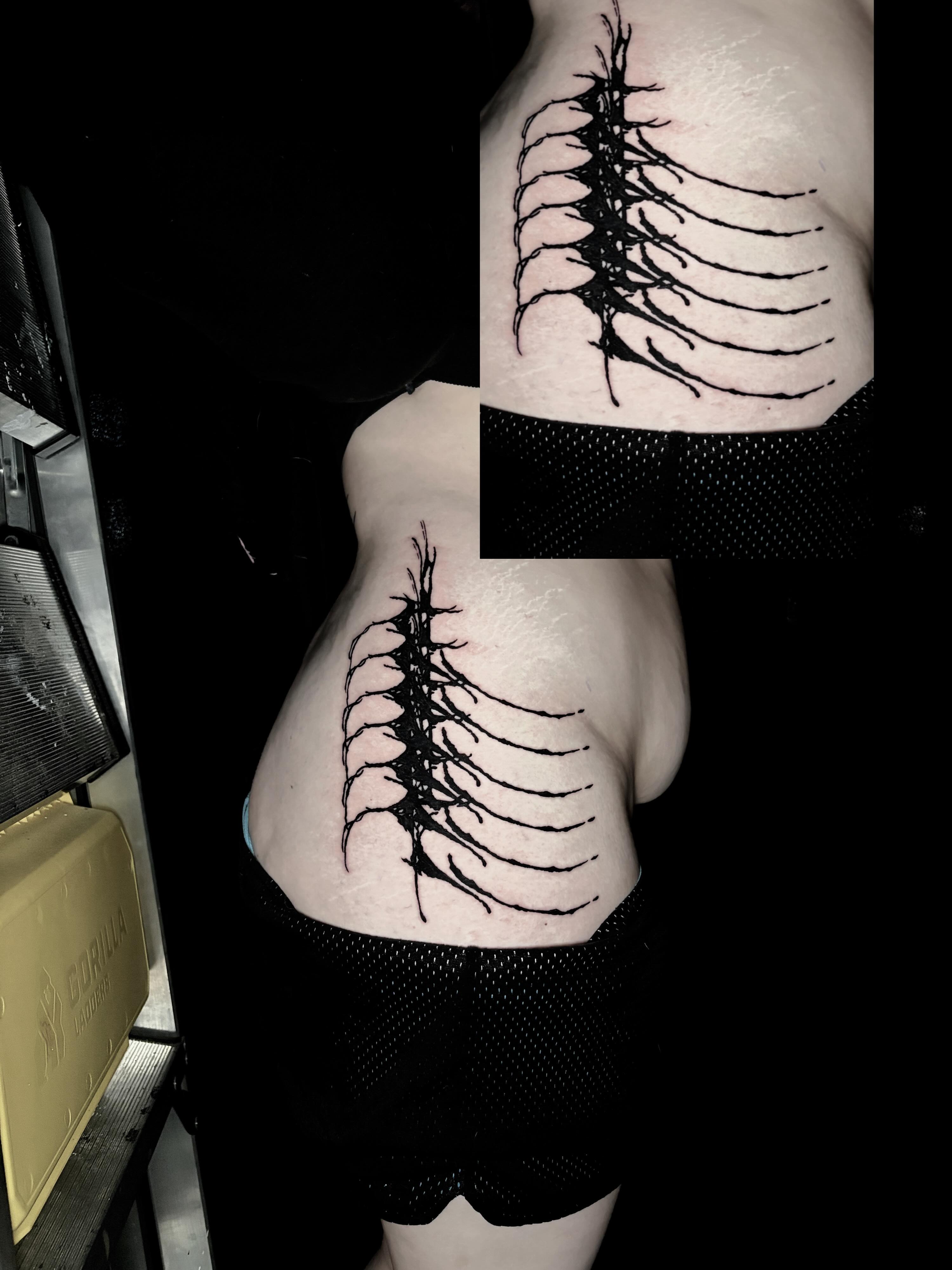 Spine black and grey tattoo on the ribs by Dev