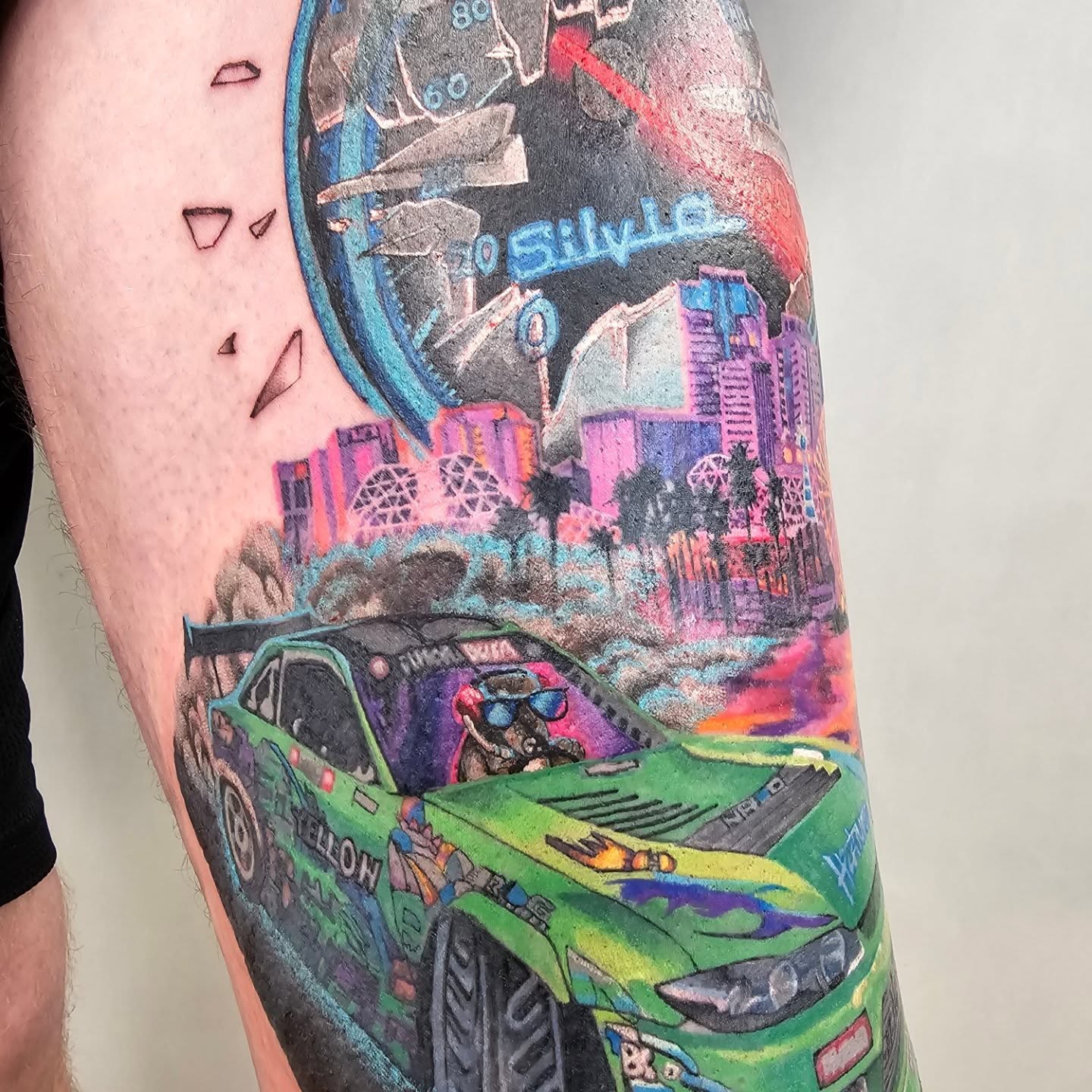 Drift car realism tattoo on the forearm by Tucker