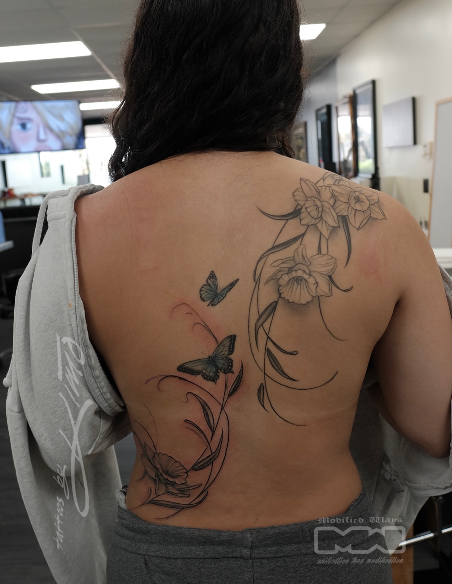 Butterflies and flowers realism tattoo on the back by Kansas City tattoo artist