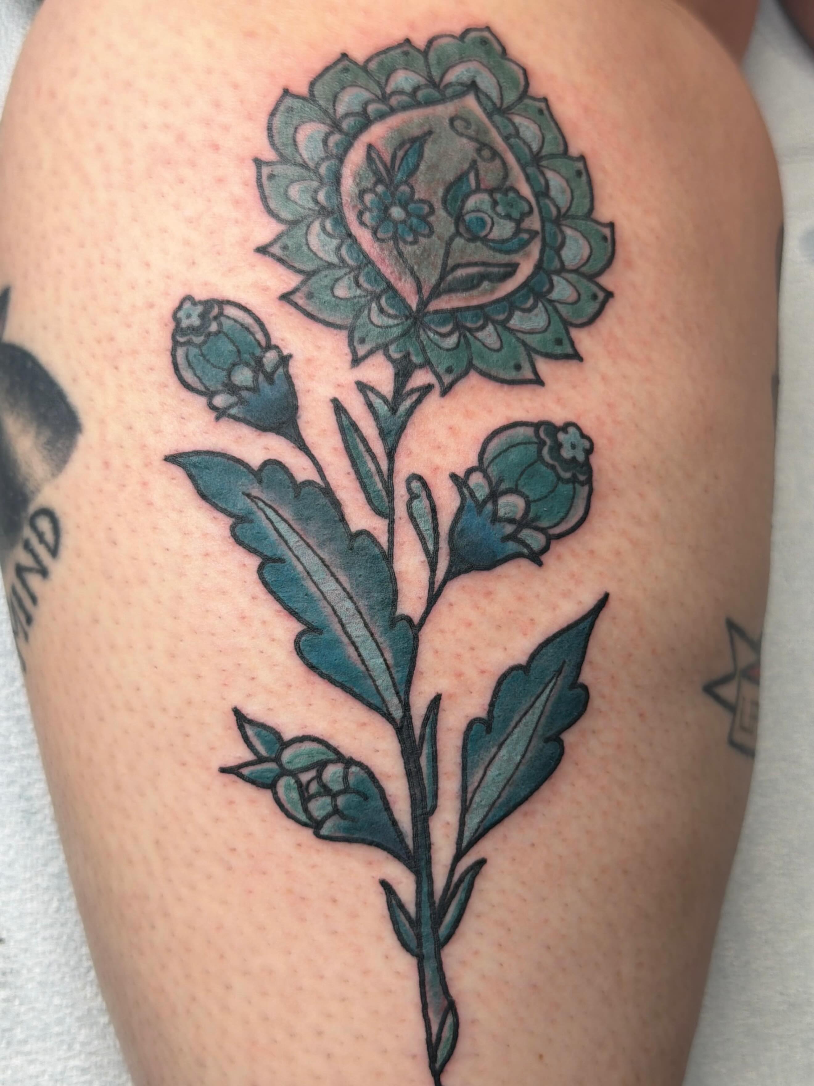 Flower American traditional tattoo on the thigh by Andrea Lynne Hastings-Craven Tattoo Artist, Cleveland, Ohio