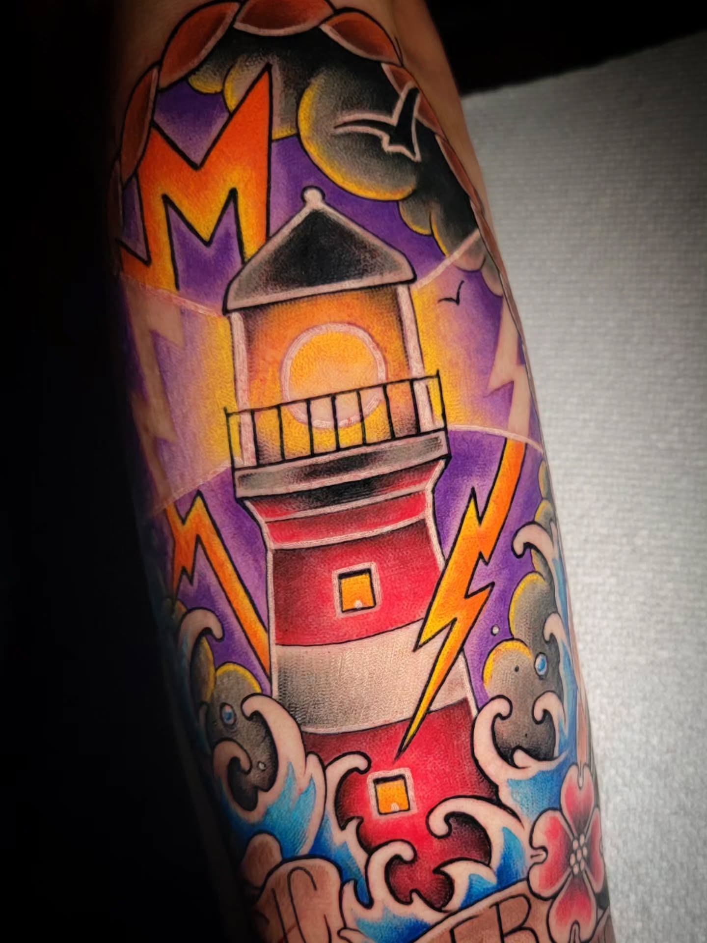 Lighthouse American traditional tattoo on the forearm by Randyz Tattyz