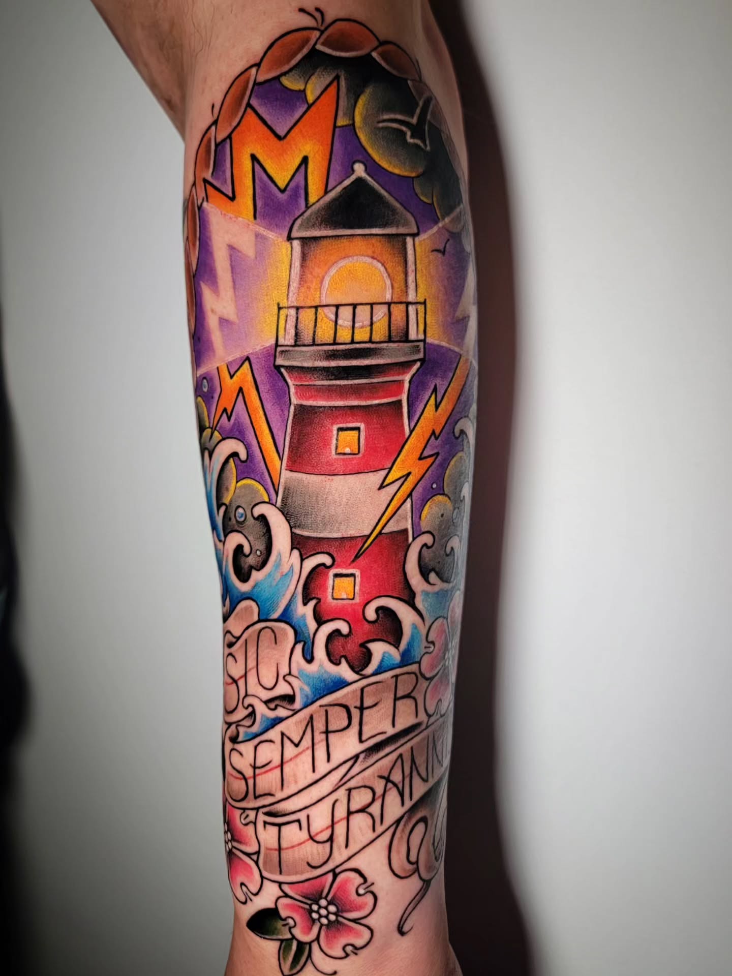 Lighthouse American traditional tattoo on the forearm by Randyz Tattyz