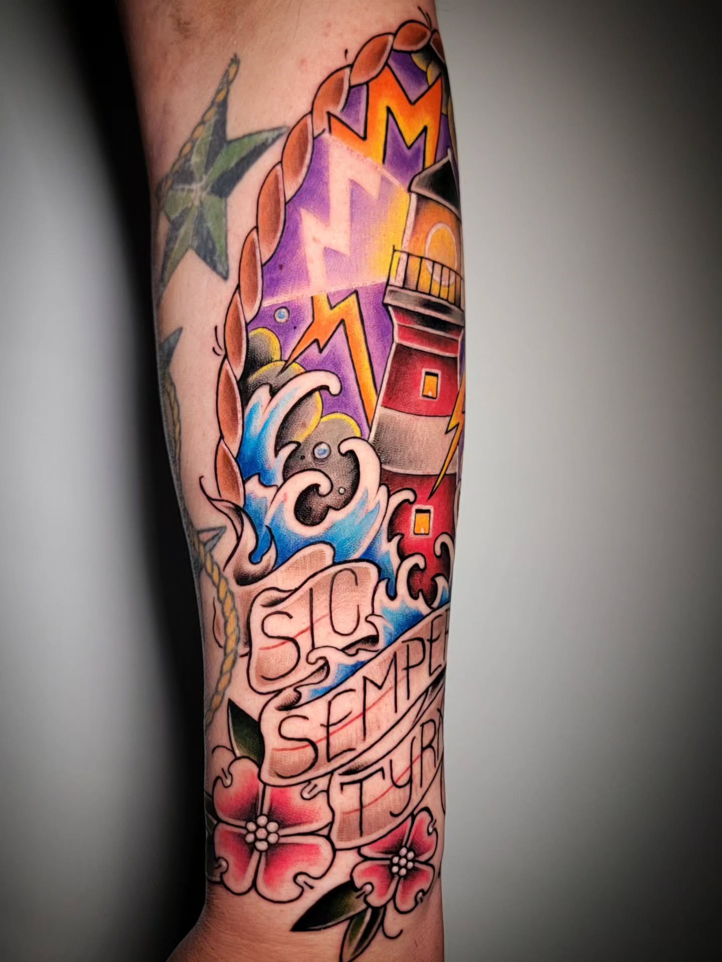 Lighthouse and waves American traditional tattoo on the forearm by Randyz Tattyz