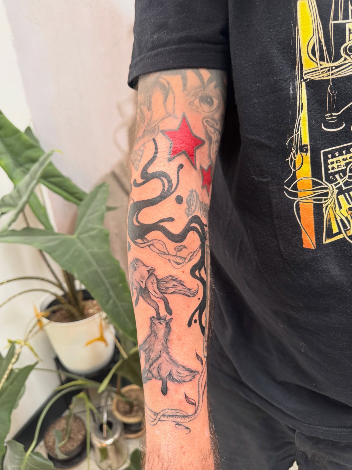Foxes and stars neo-traditional tattoo on the forearm by Sam Padilla