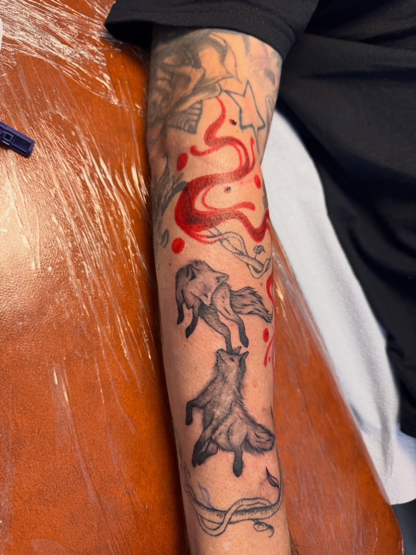 Foxes and flames American traditional tattoo on the forearm by Sam Padilla