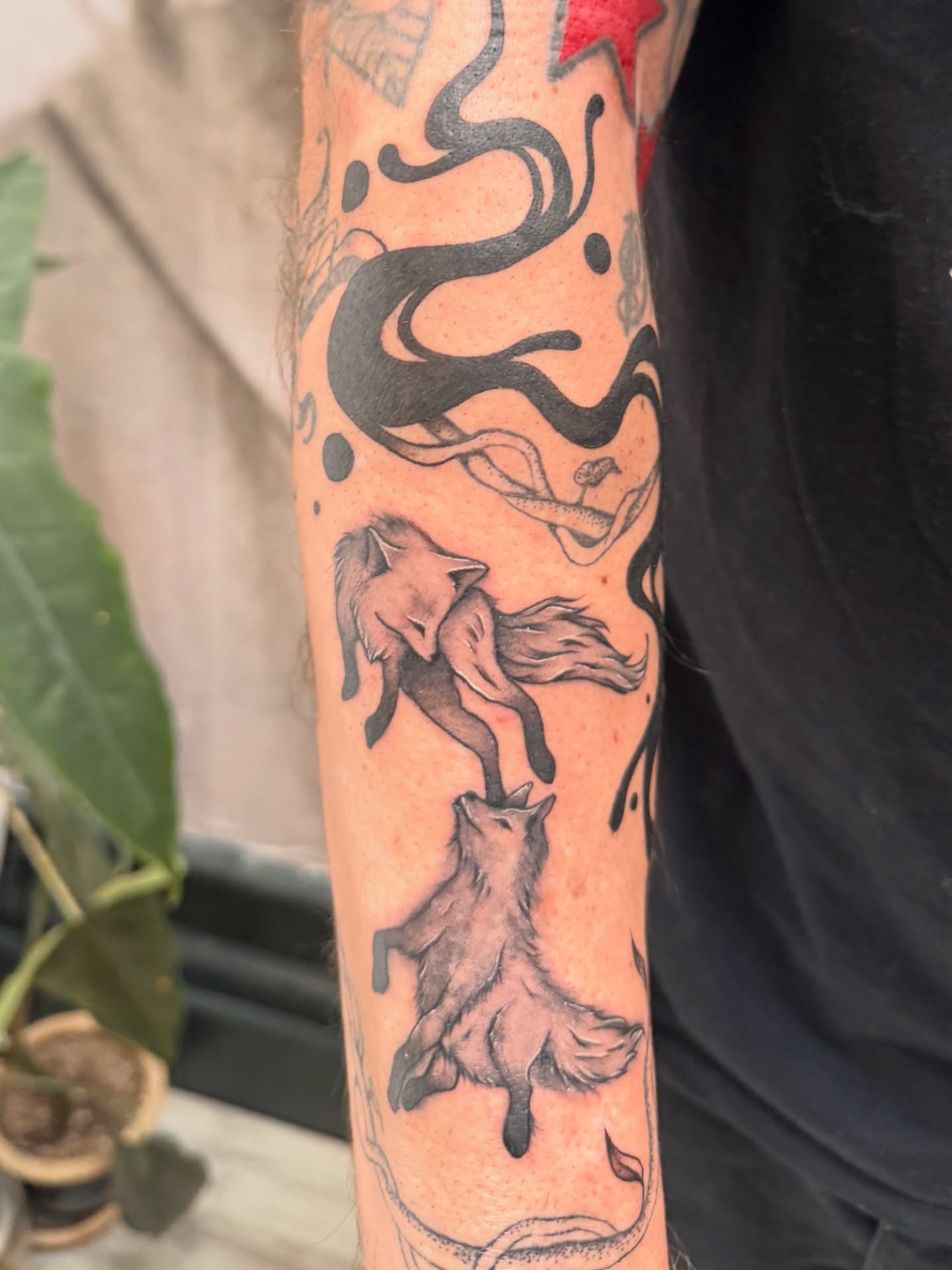 Foxes black and grey tattoo on the forearm by Sam Padilla